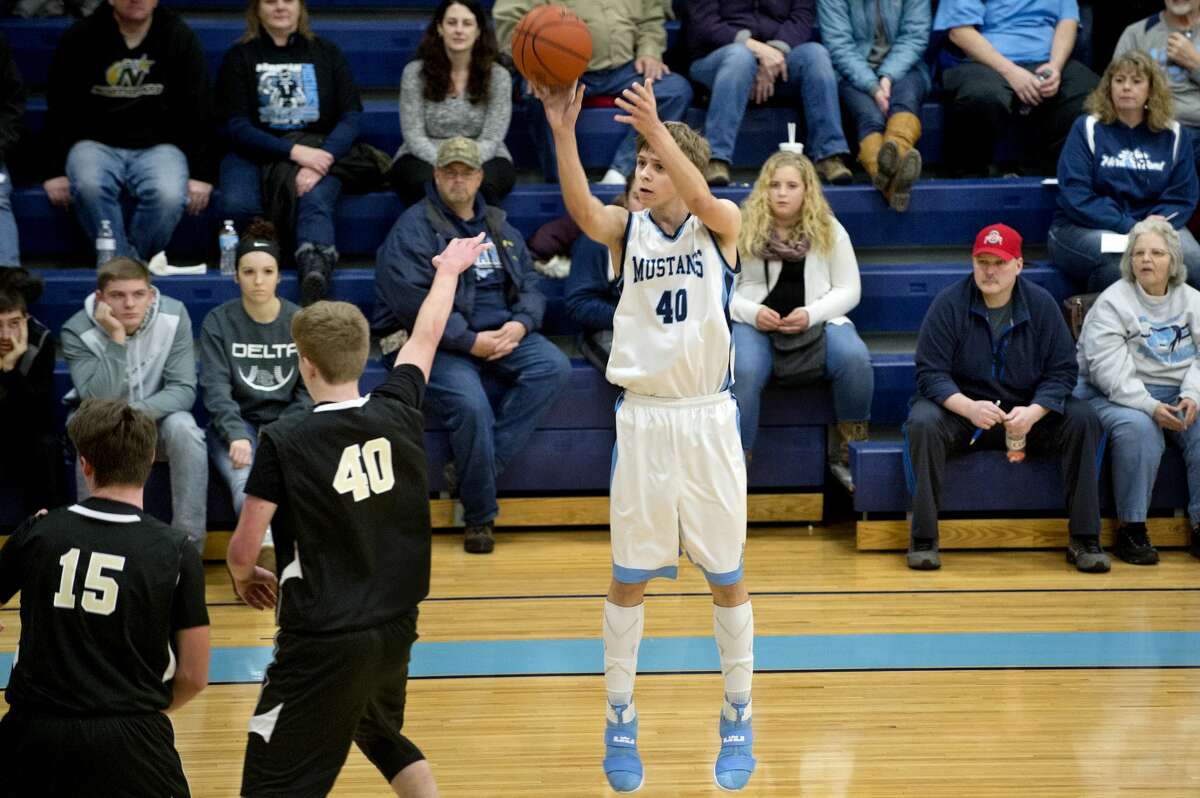 BRITTNEY LOHMILLER | blohmiller@mdn.net Meridian's Lucas Lueder shoots for three point in the first half of the Tuesday evening game against Bullock Creek. Meridian defeated Bullock Creek 52-38.