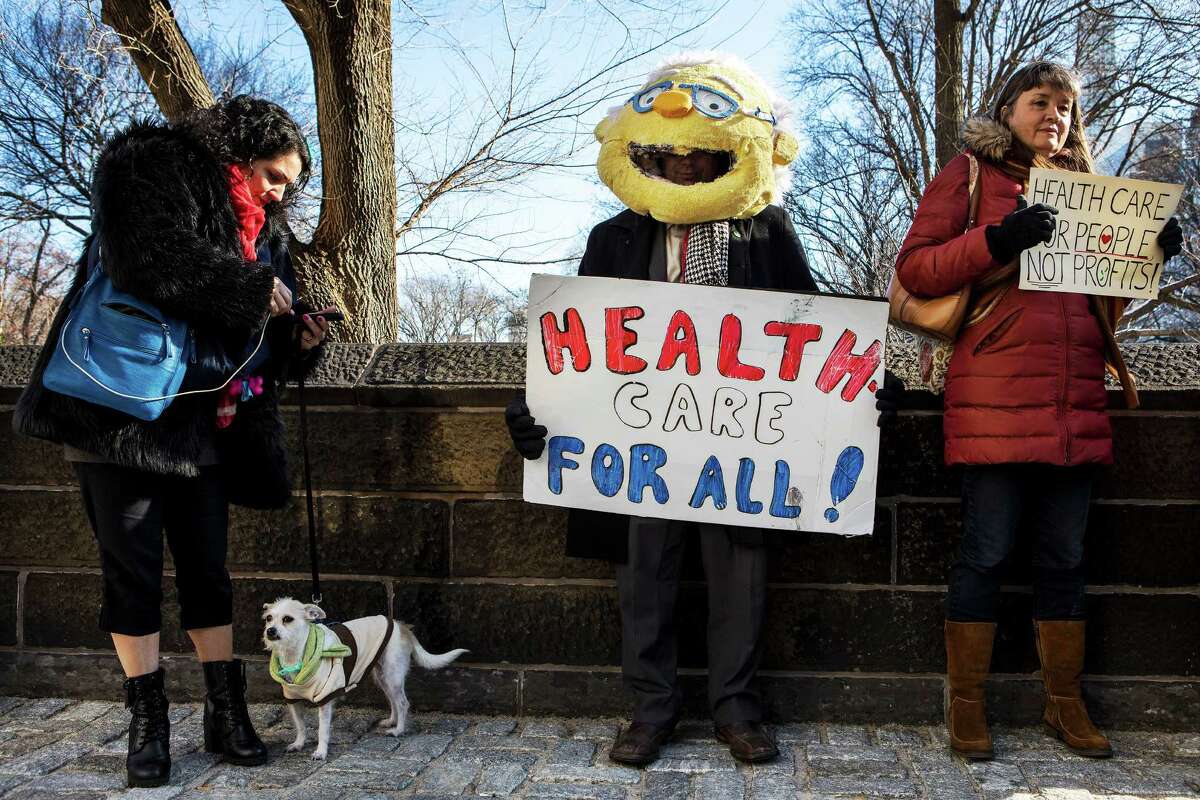Protesters gather at the Trump International Hotel & Tower in Columbus Circle to demonstrate against Republican plans to repeal President Barack ObamaÂ?’s health care legislation, in New York, Jan. 15, 2017. (Demetrius Freeman/The New York Times)