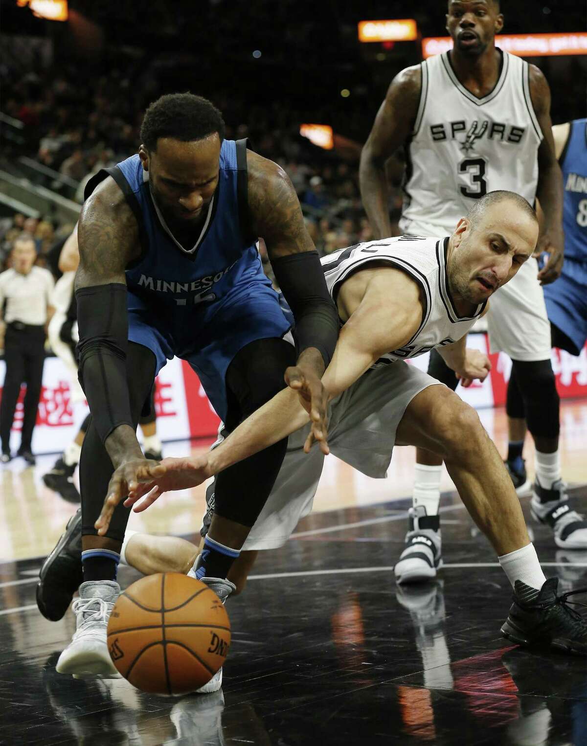 Manu Ginobili fights for a loose ball against Minnesota on Jan. 17.