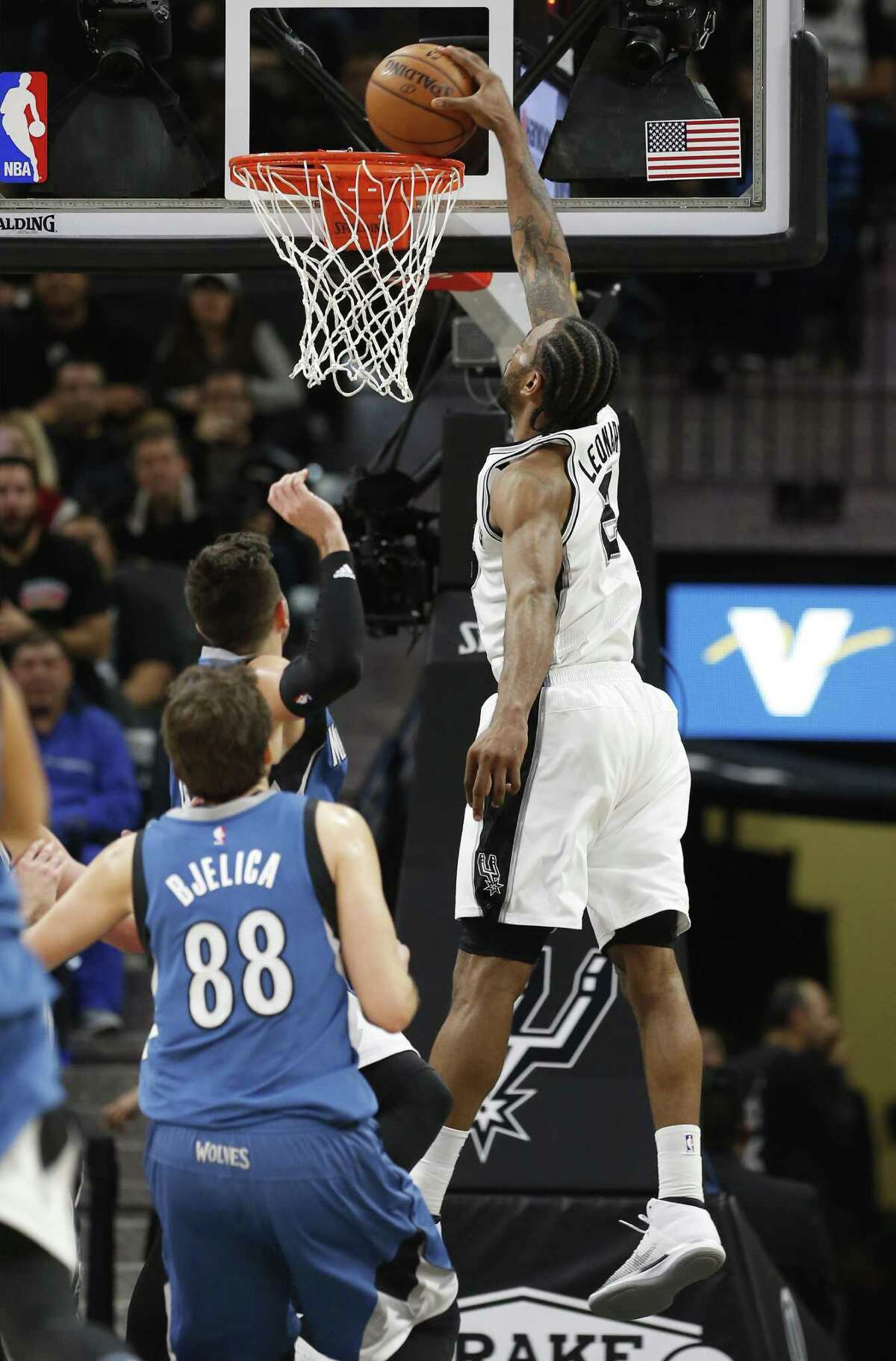 Spurs' Kawhi Leonard (02) goes in for a dunk against Minnesota Timberwolves' Ricky Rubio (09) during their game at the AT&T Center on Tuesday, Jan. 17, 2017. Spurs defeated the Timberwolves, 122-114. (Kin Man Hui/San Antonio Express-News)