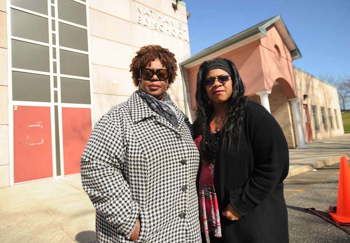 Community advocate and fellow Roodner Court resident Deidra Davis, left, and Norwalk Board of Education member Shirley Mosby outside the former Nathaniel Ely School in Norwalk, Conn. on Wednesday, April 13, 2016. There is a proposal to open three new schools in the city to deal with overcrowding, including Nathaniel Ely which is adjacent to the Roodner Court public housing complex.