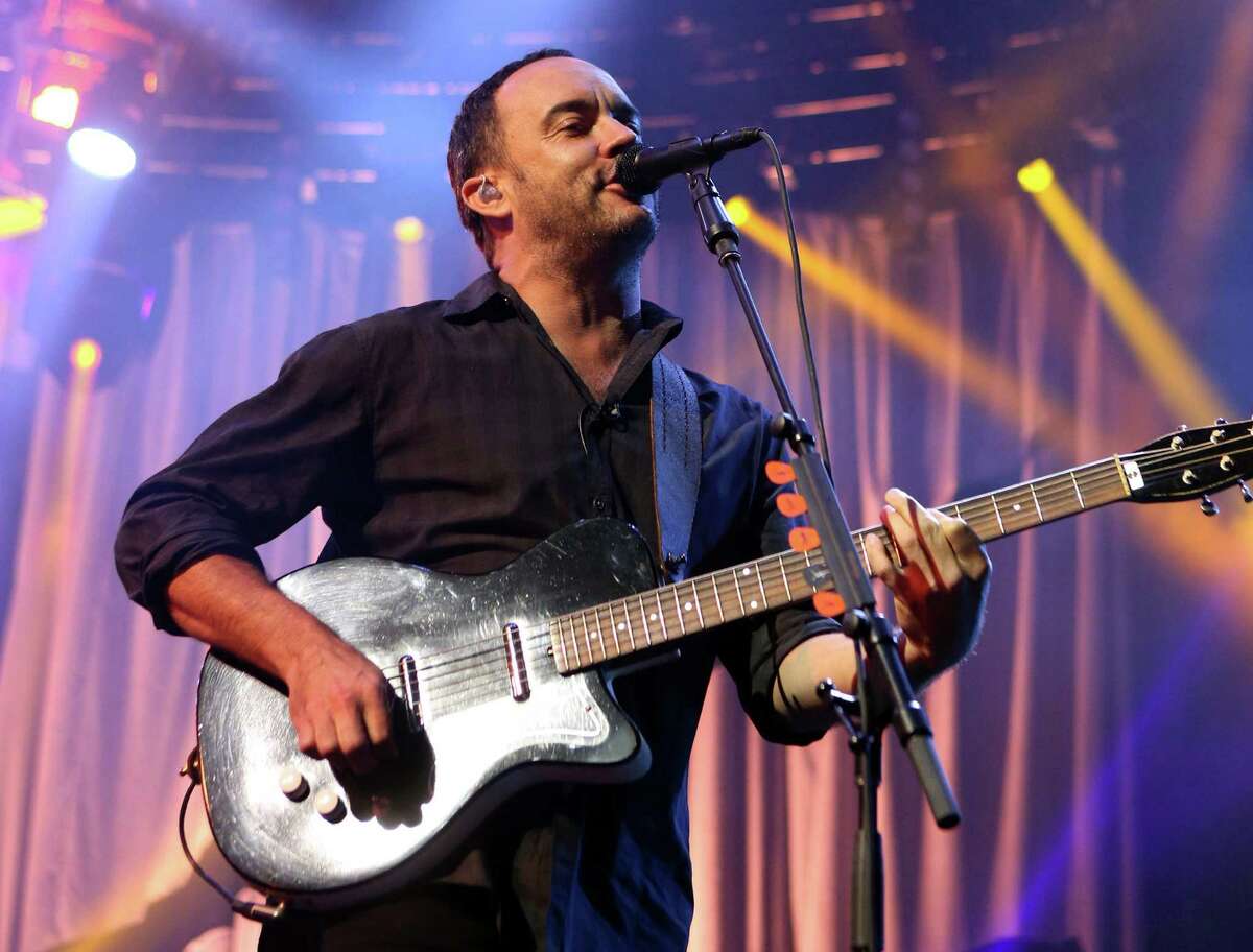 FILE - In this June 28, 2013 file photo, Dave Matthews of The Dave Matthews Band performs on stage at the Susquehanna Bank Center in Camden, N.J. Emily Kraus , one of Matthew's fans pulled over to give a stranded cyclist a ride and realized the hitchhiker was none other than Matthews. His bike had broken down Saturday, July 13, before a show in Hershey, Pa. (Photo by Owen Sweeney/Invision/AP, File)