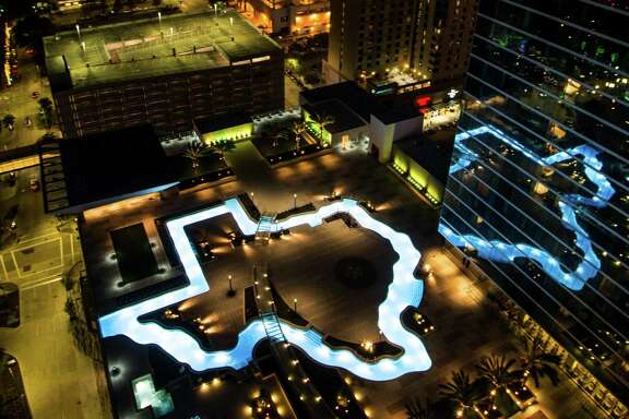 The Texas-shaped lazy river pool is lit up during the grand lighting ceremony at the Marriott Marquis hotel on Monday, Dec. 26, 2016, in Houston. ( Brett Coomer / Houston Chronicle )