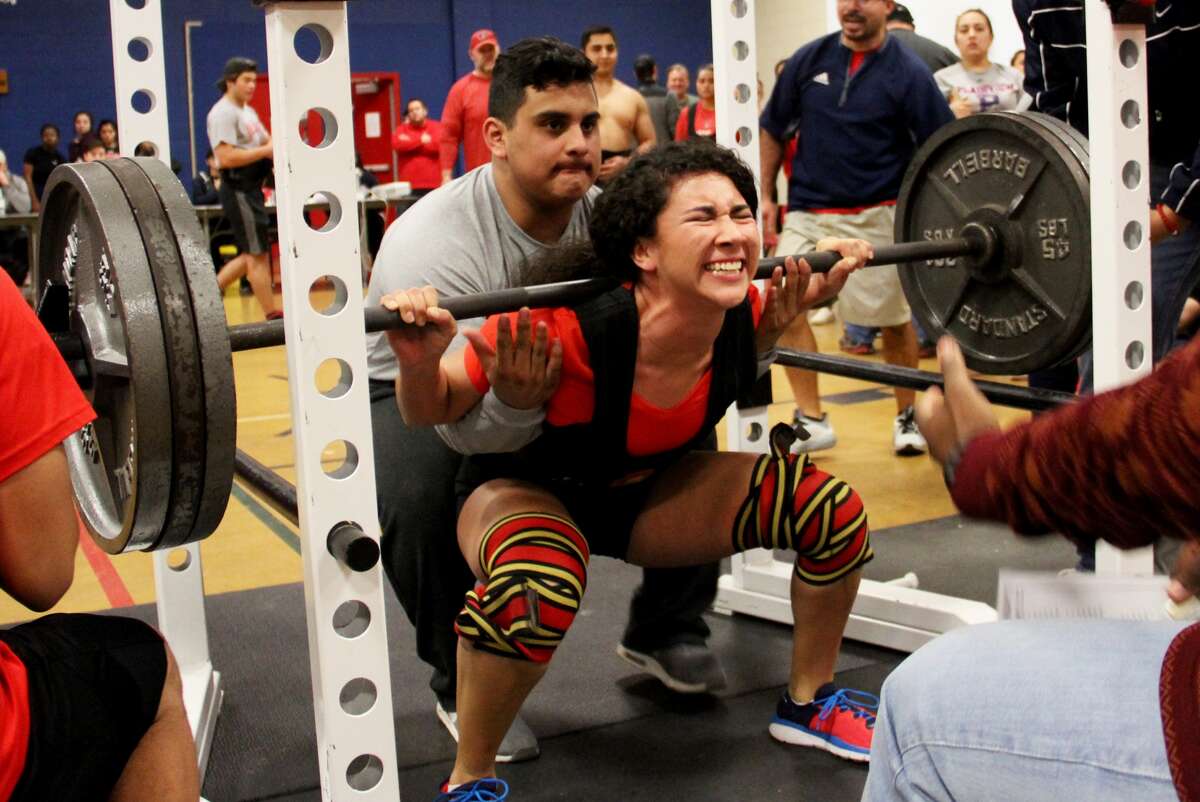 The strain shows on the face of Plainview senior Angela Banda as she tries to stand up and execute a squat lift during the Plainview Invitational powerlifting meet.