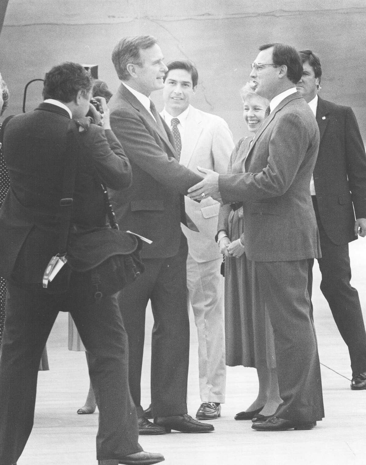 Vice President George H.W. Bush is greeted by Congressman Tom Loeffler upon his arrival in San Antonio on May 6, 1987, for a private fundraising dinner. Judge Roy Barrera is standing behind them. San Antonio Light file photo
