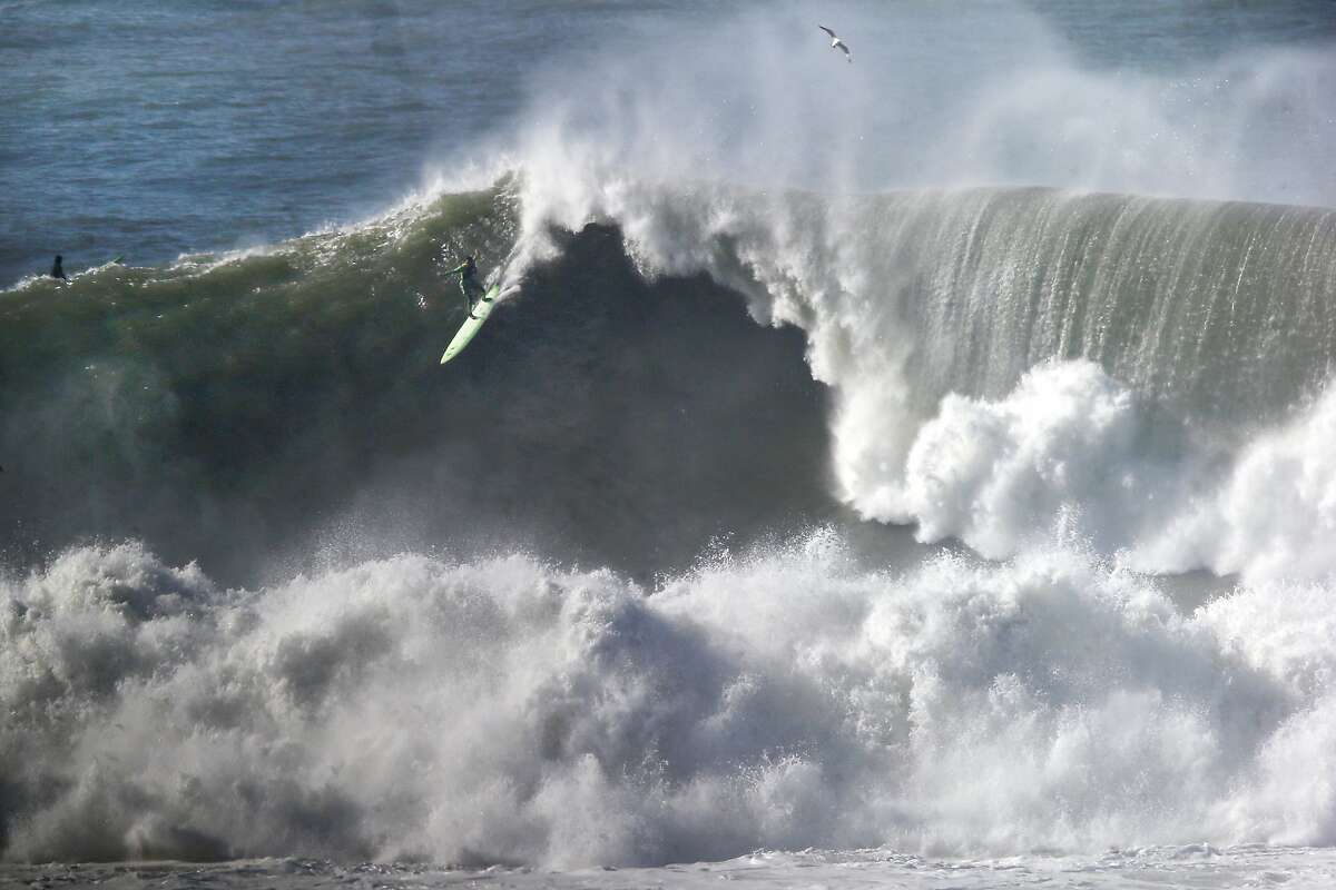 A surfer takes off on a large wave at Maverick's in Half Moon Bay, CA Wednesday, January 7, 2016.