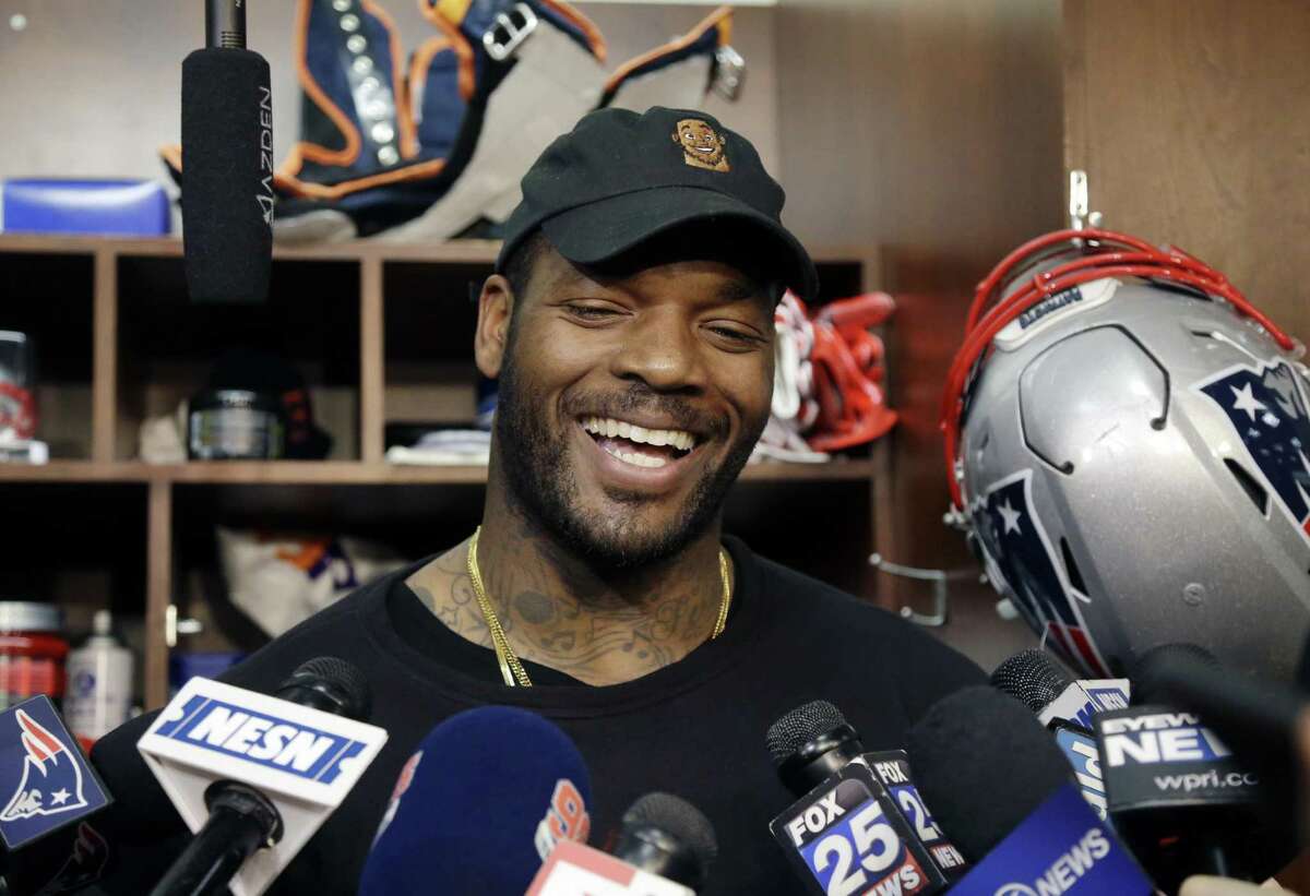 New England Patriots tight end Martellus Bennett laughs as he speaks to media at his locker after practice on Jan. 11, 2017, in Foxborough, Mass.