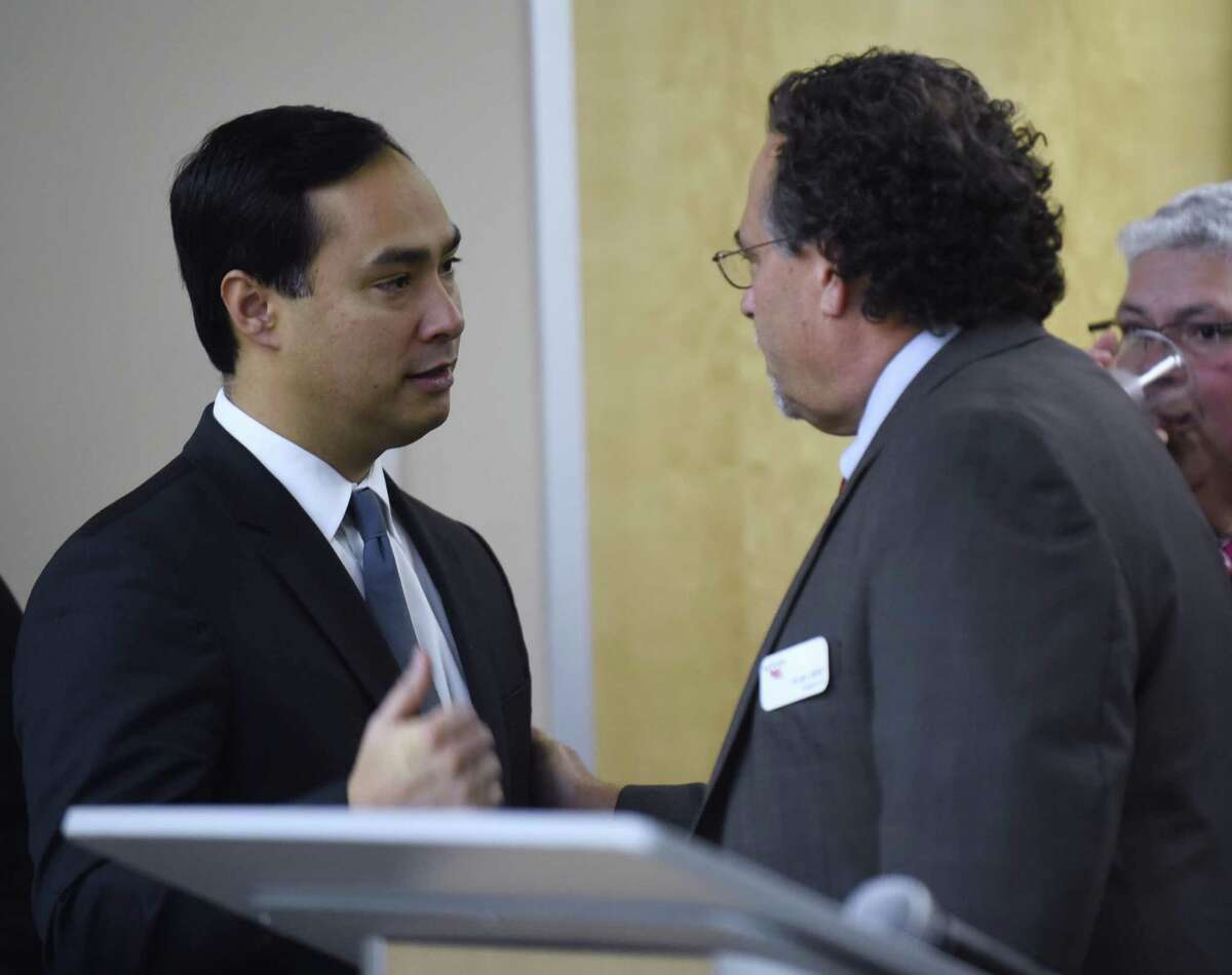 U.S. Rep. Joaquin Castro, left, greets Roland Mower, CEO of Port San Antono, during an event celebrating the 100th anniversary of the founding of Kelly Field, which later became Kelly Air Force Base and then Port San Antonio, on Wednesday, Jan. 18, 2017.