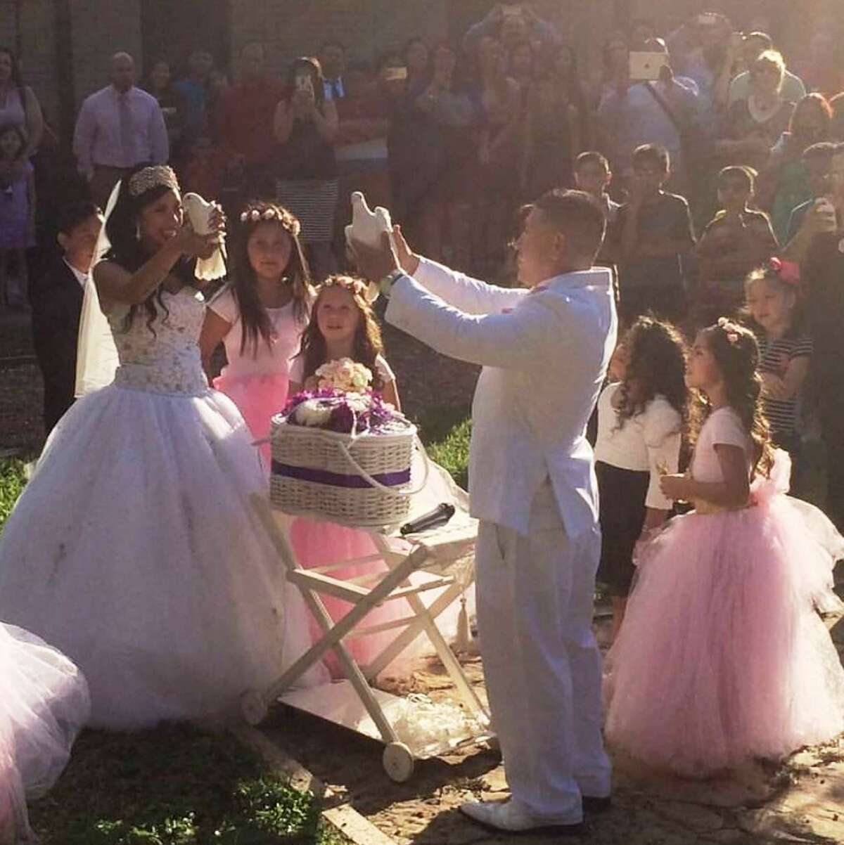 Lisa and Travis Luce prepare to release pigeons during their August 2016 wedding. The couple used the crowdfunding website GoFundMe to help pay for the wedding.