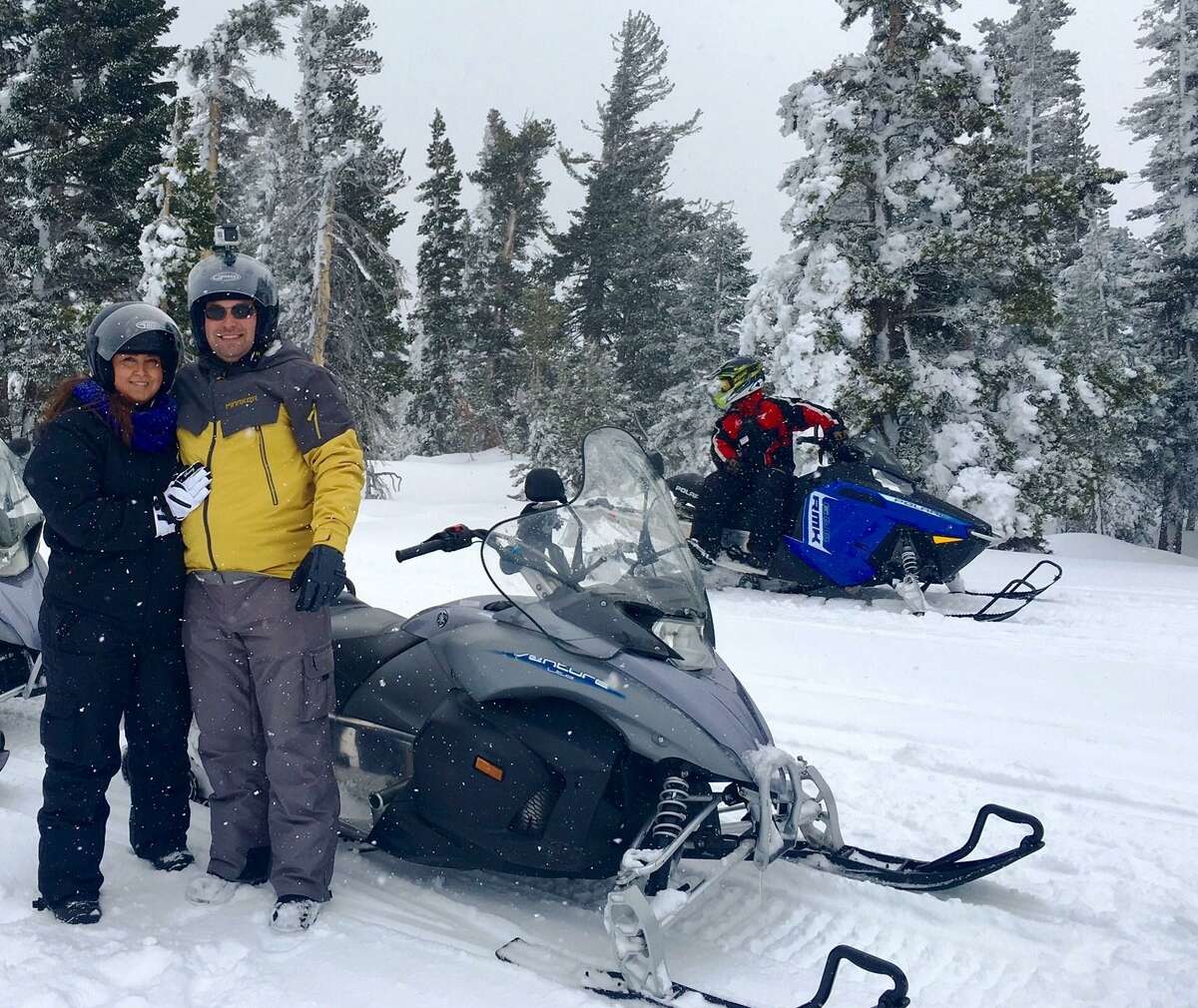 Laurie and Robert Plumas pose while snowmobiling during the 2016 honeymoon to the Lake Tahoe area. The San Antonio couple raised money to pay for most of their honeymoon on the crowdfunding website Honeyfund.