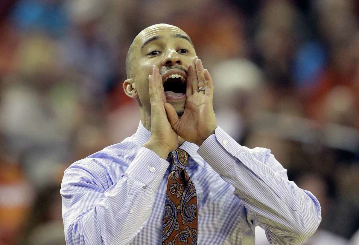 Texas head coach Shaka Smart calls to his players during the first half of an NCAA college basketball game against West Virginia, Saturday, Jan. 14, 2017, in Austin, Texas. (AP Photo/Eric Gay)