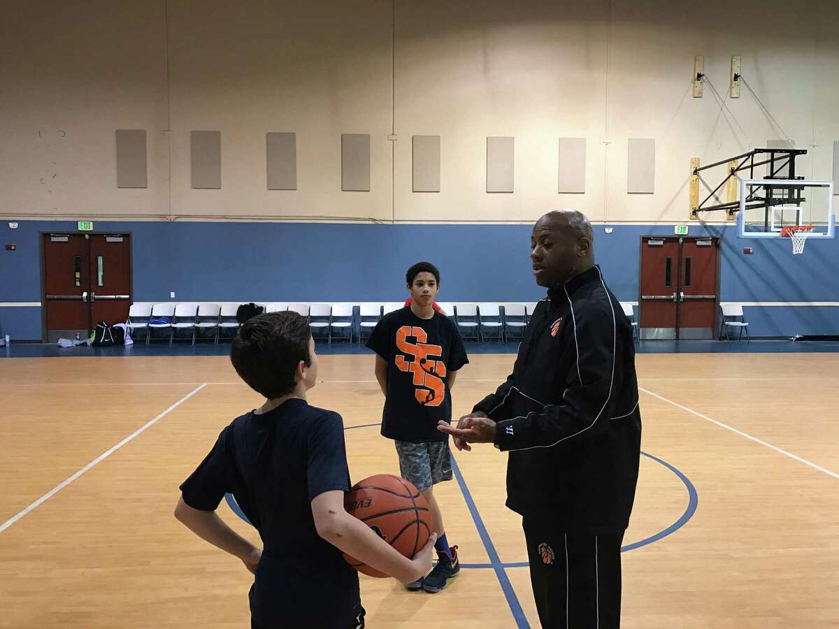 Former professional basketball player David “DJ” Jones leads practice on a recent night. Jones, who played 10 years in Europe, operates the “Shooting for Success” program on the North Side.