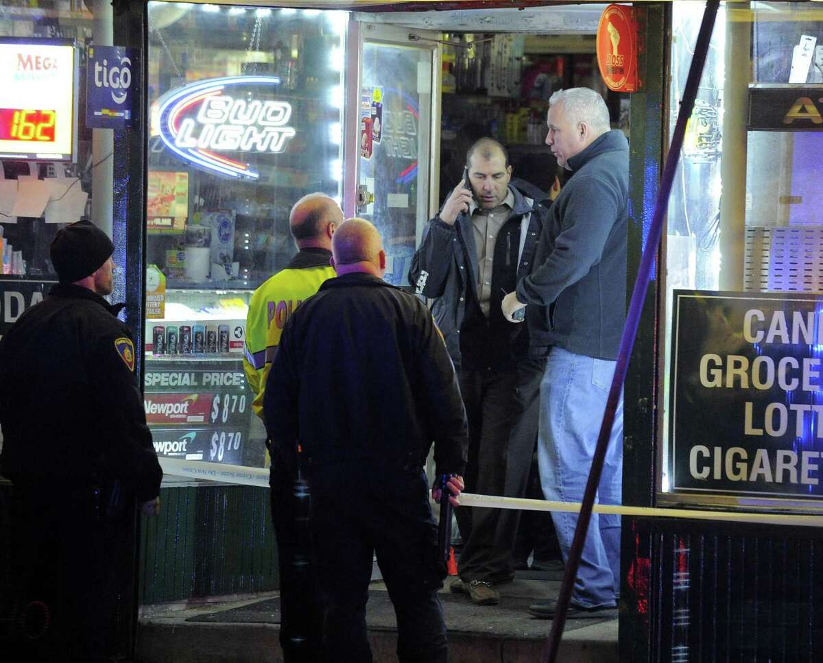 Stamford police investigate the scene of a shooting inside West Main Convenience on West Main Street in Stamford on Jan. 19, 2017. One victim was reported to have been shot in the head as police canvass the West side neighborhood for witnesses.