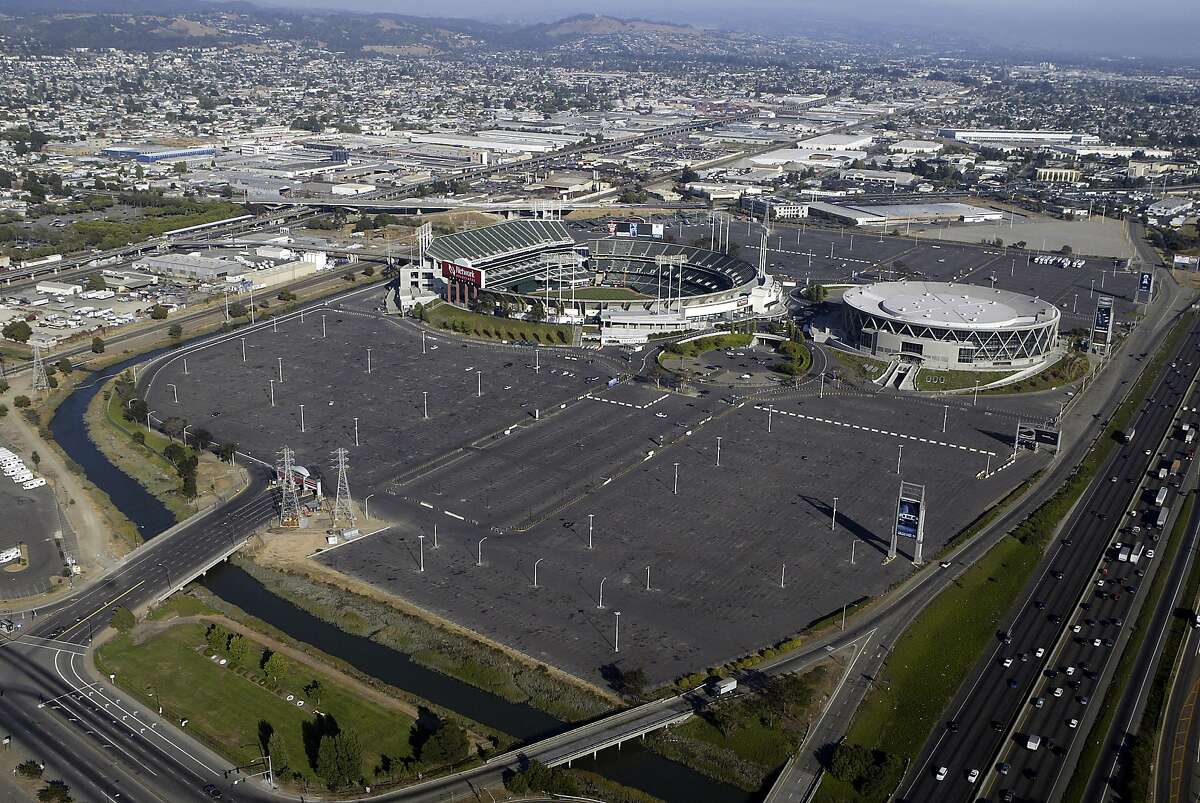 Oakland Coliseum and Oracle Arena with parking lots.