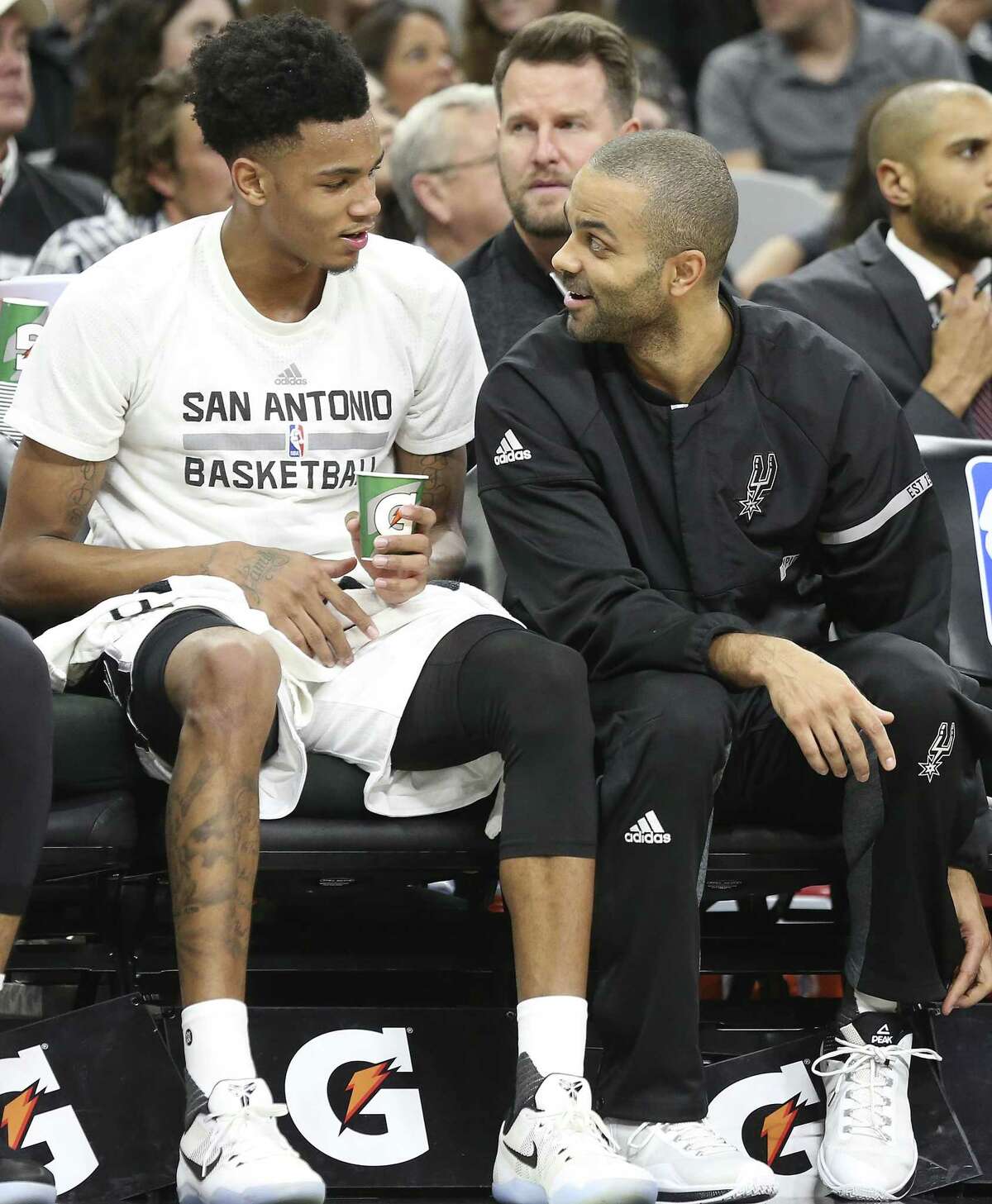 Tony Parker chats with Dejounte Murray on the bench as the Spurs host Denver at the AT&T Center on January, 19, 2017.
