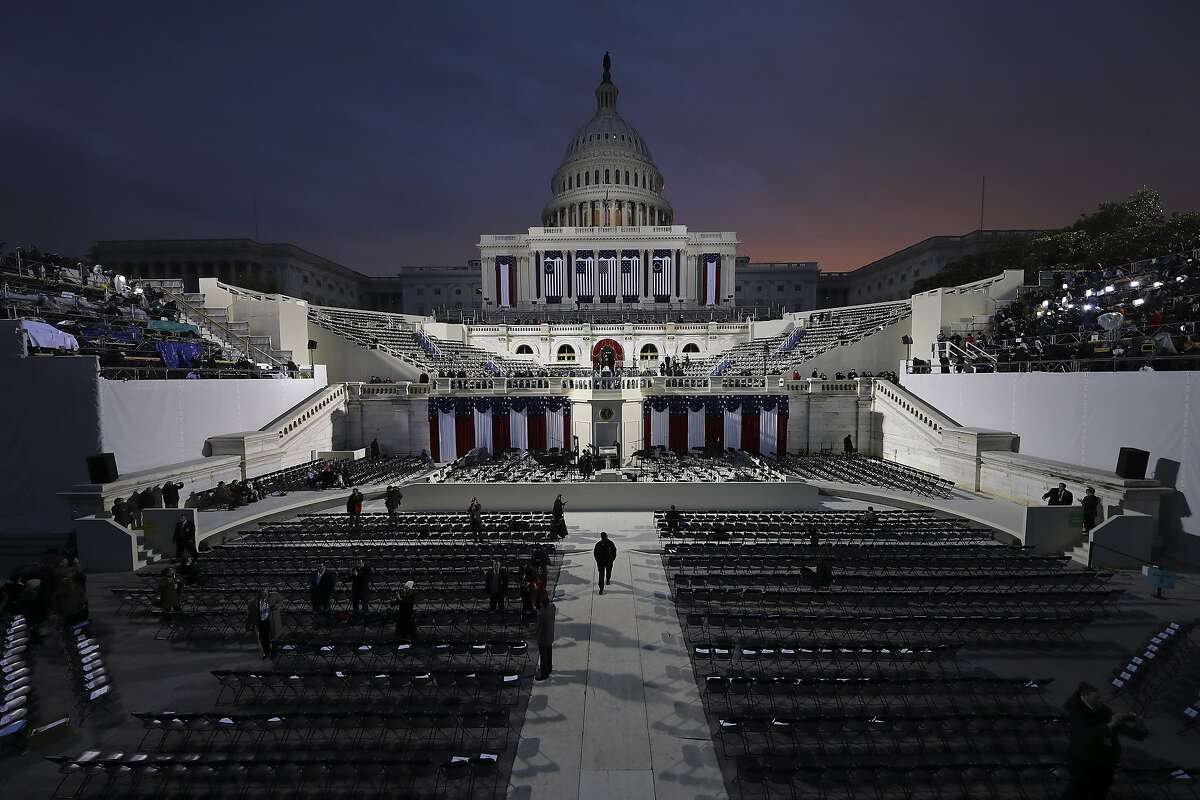 The sun begins to rise behind the Capitol in Washington, Friday, Jan. 20, 2017, hours before the presidential inauguration of Donald Trump. (Andrew Gombert via AP, Pool)
