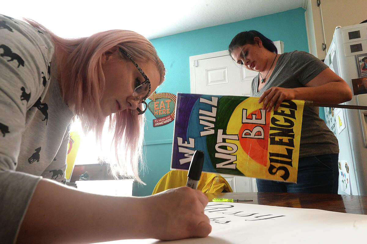 Amber Crowe (right) and Amber Barnhill work on creating their signs for Saturday's Women's March in Austin at the home of Heather Mullin Thursday. The three will join other area women in the sister march at the state capitol, which is one of many throughout the country and the world taking place in conjunction with the national event in Washington, D.C. Photo taken Thursday, January 19, 2017 Kim Brent/The Enterprise