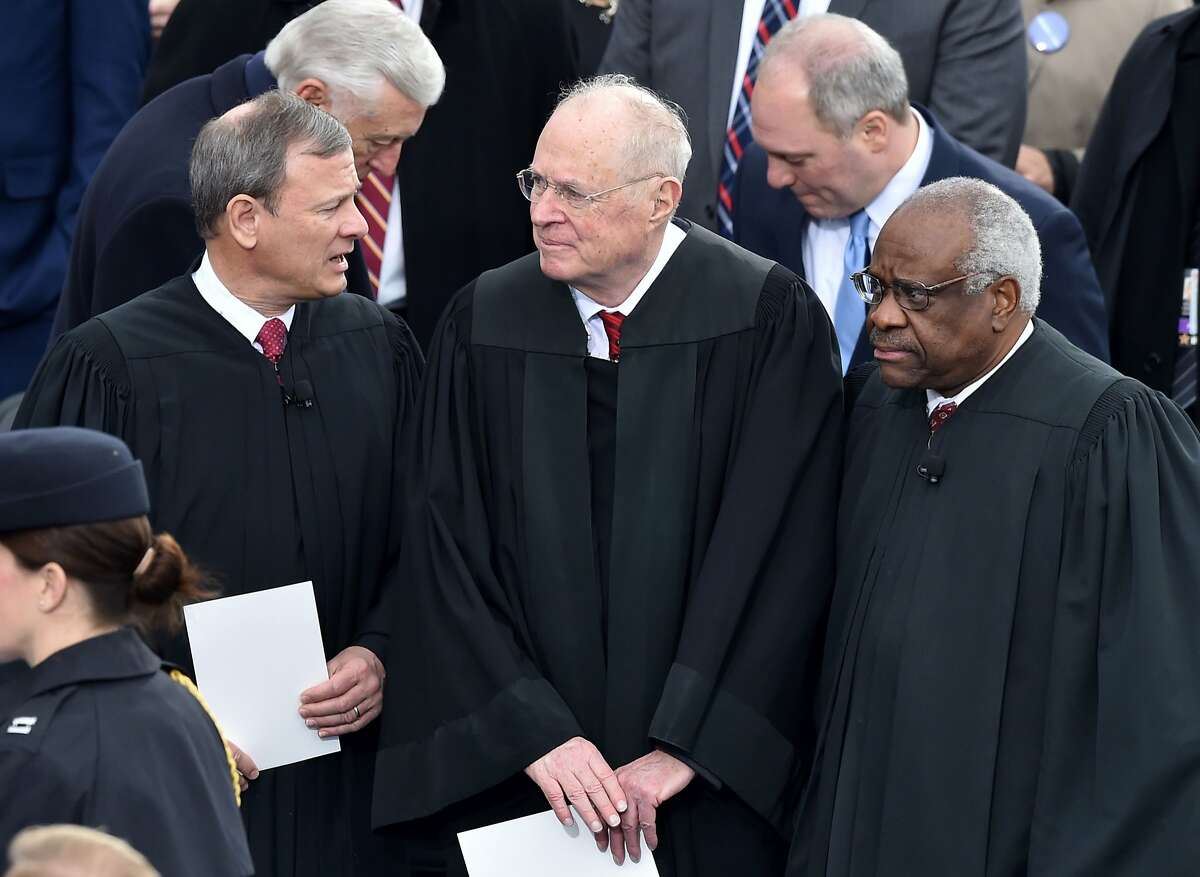 L-R: US Chief Justice John Roberts, Justice Anthony Kennedy and Justice Clarence Thomas on the platform of the US Capitol in Washington, DC, on January 20, 2017, before the swearing-in ceremony of US President-elect Donald Trump. / AFP PHOTO / Paul J. RichardsPAUL J. RICHARDS/AFP/Getty Images