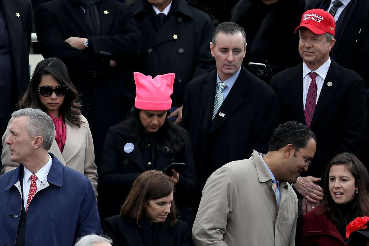 A woman wearing a pink knit hat representing the Women's March, stands among spectators at the U.S. Capitol on January 20, 2017 in Washington, DC. In today's inauguration ceremony Donald J. Trump becomes the 45th president of the United States. (Photo by Joe Raedle/Getty Images)