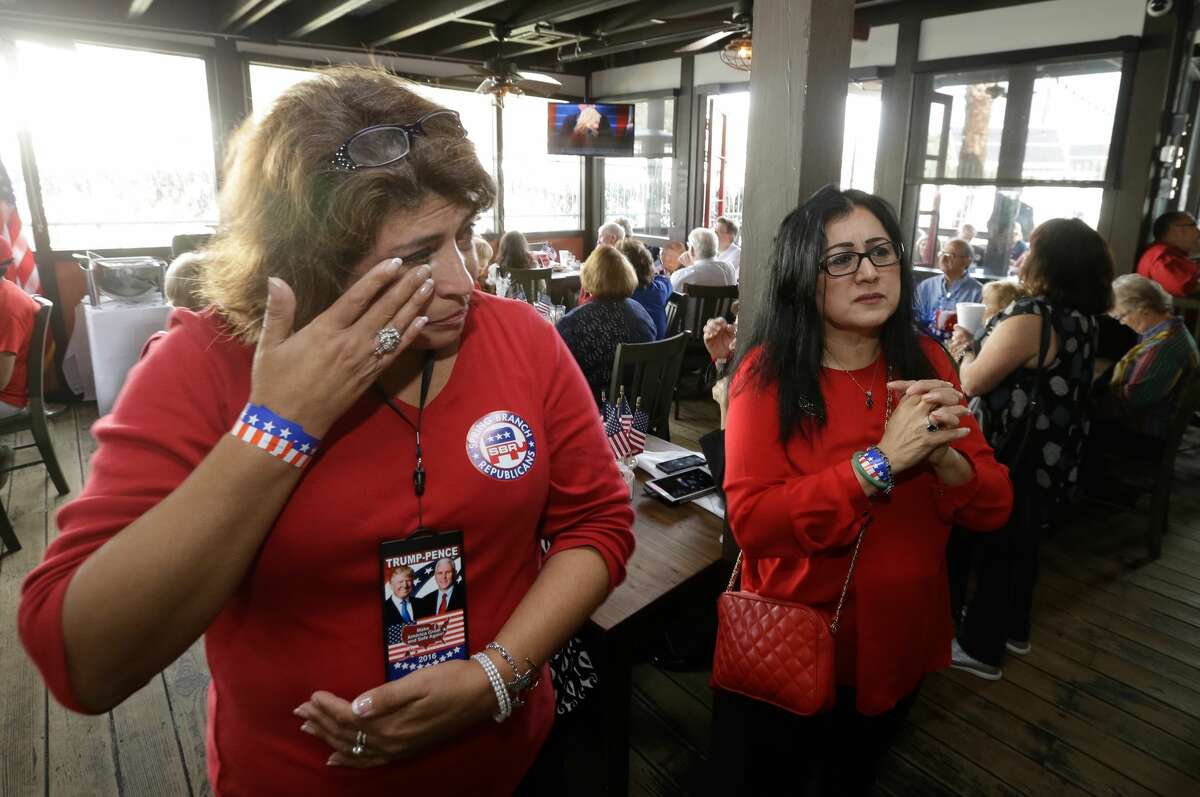 Cynthia Resendez, left, wipes away tear as she and Hope Cruz watch the opening prayer on TV during the GOP Inaugural Watch Party at Ninfa's, 2704 Navigation Blvd., Friday, Jan. 20, 2017.