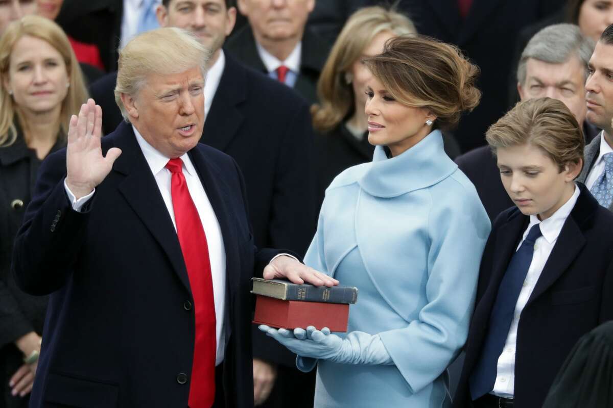 U.S. President Donald Trump takes the oath of office as his wife Melania Trump holds the bible and his son Barron Trump looks on, on the West Front of the U.S. Capitol on January 20, 2017 in Washington, DC. In today's inauguration ceremony Donald J. Trump becomes the 45th president of the United States. (Photo by Chip Somodevilla/Getty Images)