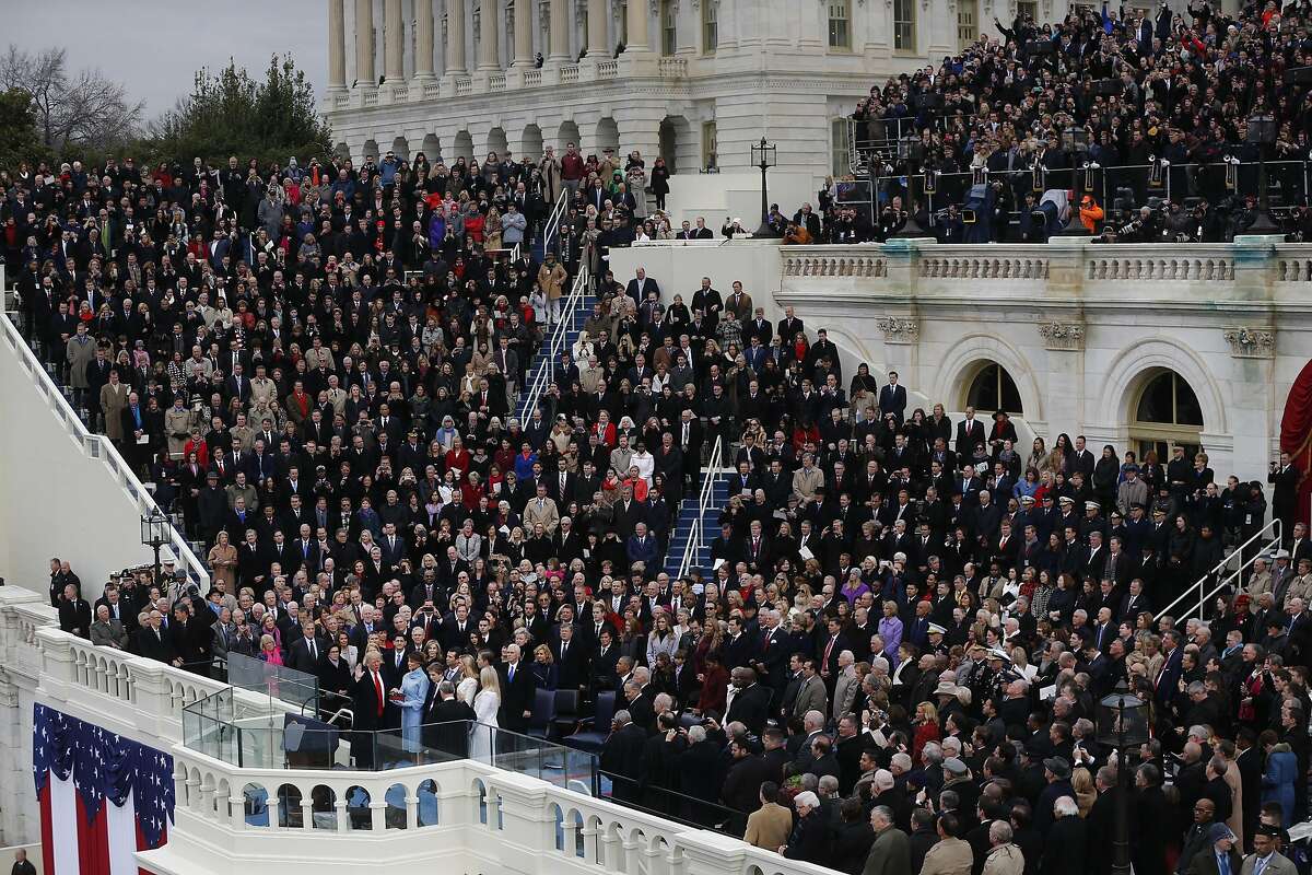 U.S. President-elect Donald Trump takes the oath of office as First Lady-elect Melania Trump stands during the 58th presidential inauguration in Washington, D.C., U.S., on Friday, Jan. 20, 2017. Donald Trump will become the 45th president of the United States today, in a celebration of American unity for a country that is anything but unified. Photographer: Andrew Harrer/Bloomberg