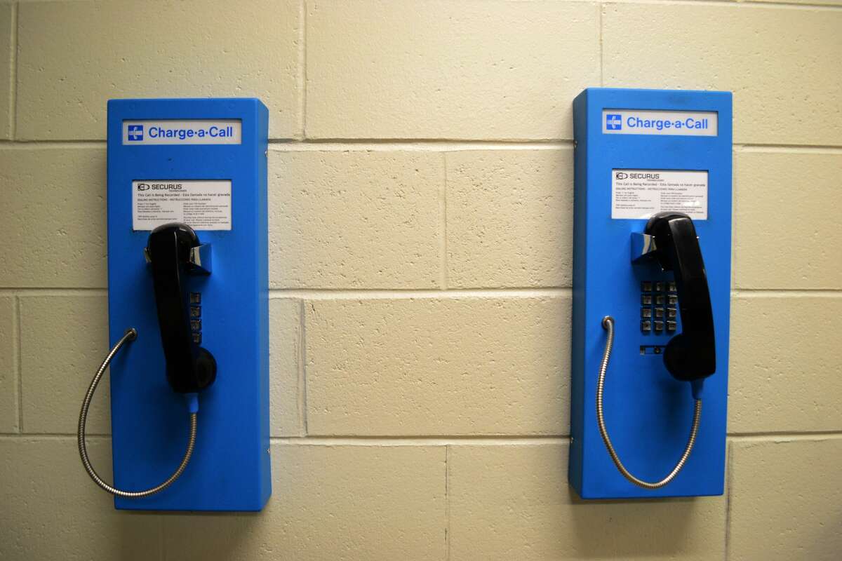 FILE - Pay phones at Midland County Jail