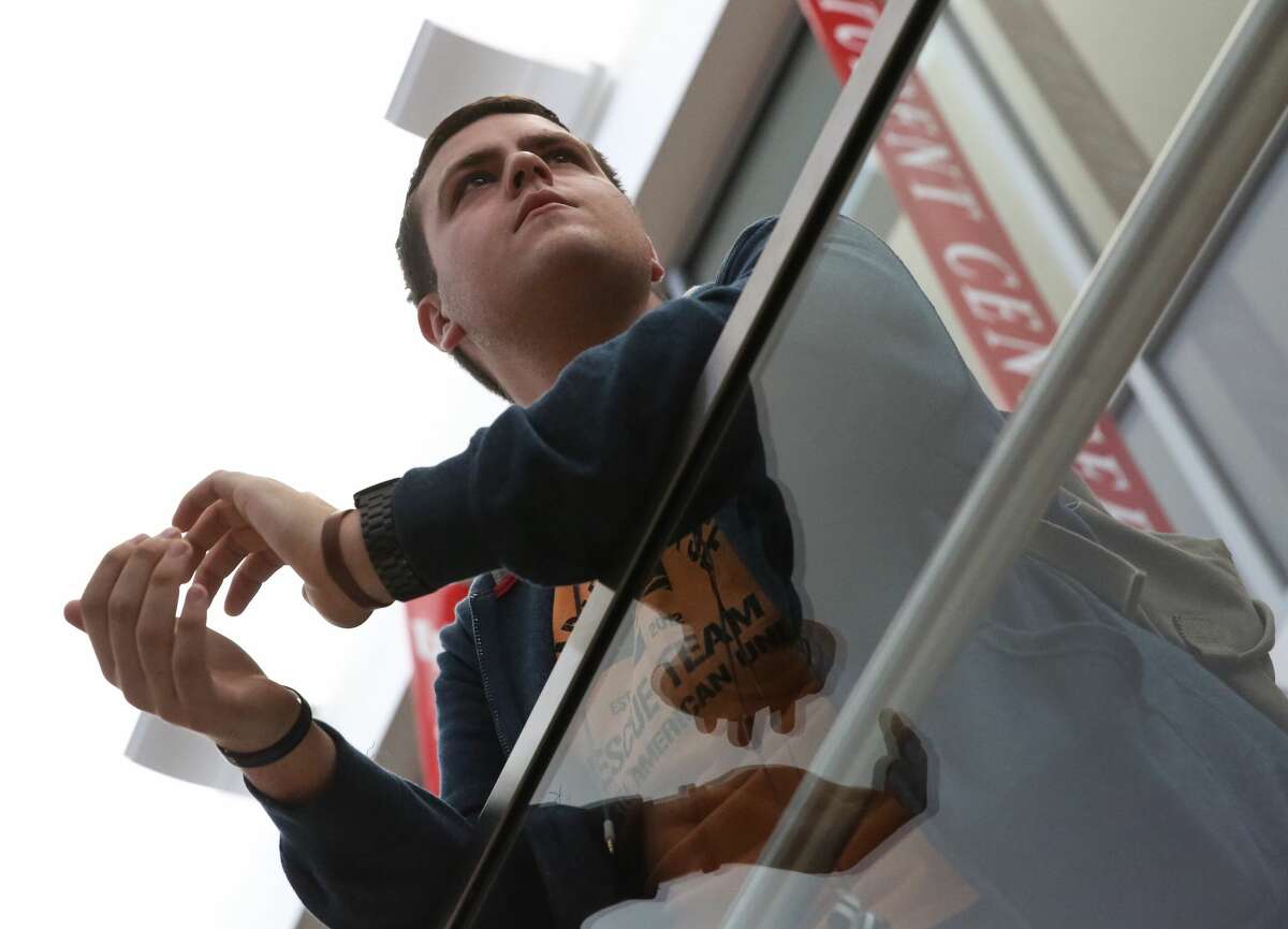 University of Houston sophomore student Jordan Sides claps for President Donald J. Trump's inauguration speech at the school's watch party at student center on Friday, January 20, in Houston.