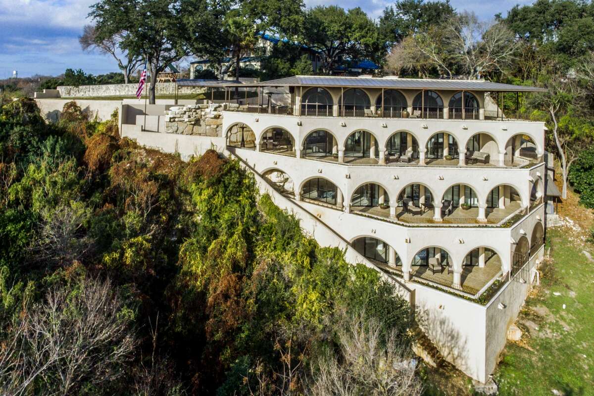 Driving north on U.S. 281, it's hard to miss the miniature coliseum-like mansion perched on a bluff overlooking the Olmos Dam since 1986. The 6,500-square-foot "landmark residence" is now on the market for $4,999,000. A luxe history and list of amenities tie the price tag to the home.