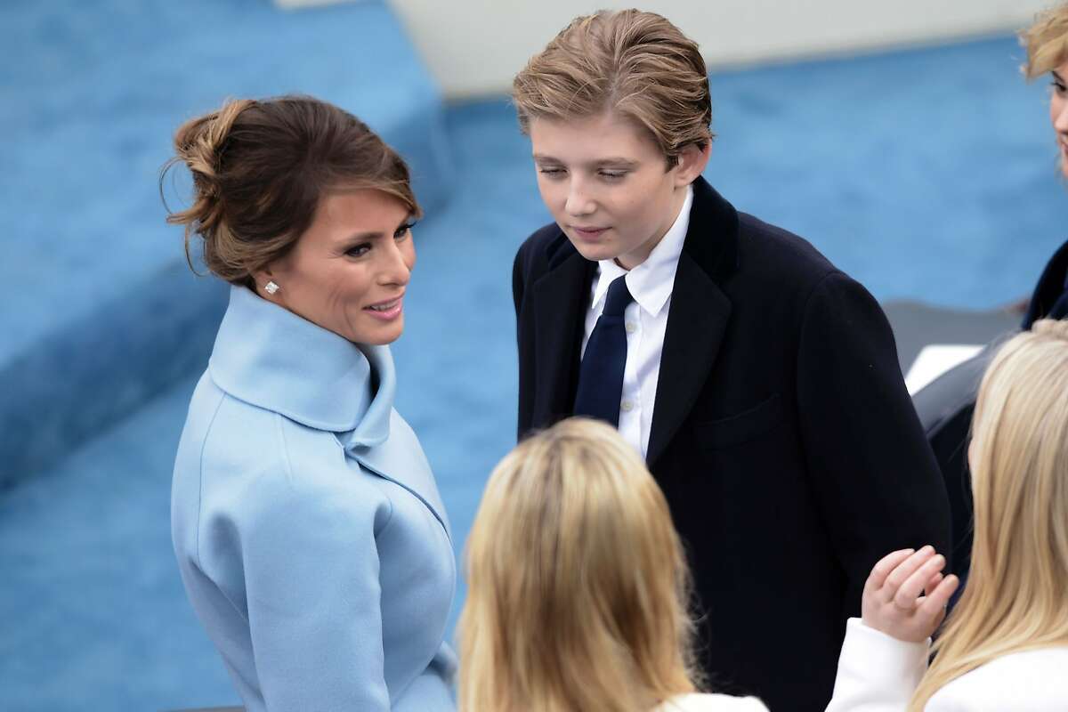 US First Lady Melania Trump and her son Barron Trump chat as they wait for the beginning of the swearing-in ceremony of US 45th President Donald Trump in front of the Capitol in Washington on January 20, 2017.
