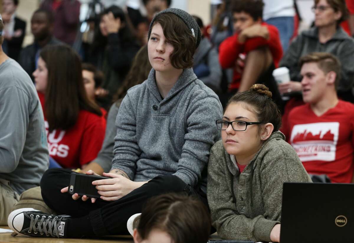 University of Houston students watch President Donald J. Trump searing into office as the 45th president of the United States on the Monumental Stairs at student center on Friday, January 20, in Houston. ( Yi-Chin Lee/ Houston Chronicle)