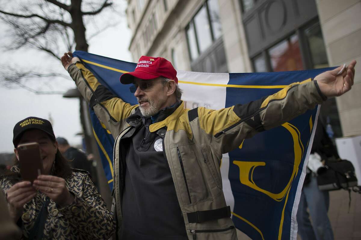 Tom Rooney of New Jersey raises his hand the moment President Donald Trump finishes his oath of office and is confirmed, Friday, Jan. 20, 2017, in Washington D.C.. ( Marie D. De Jesus / Houston Chronicle )