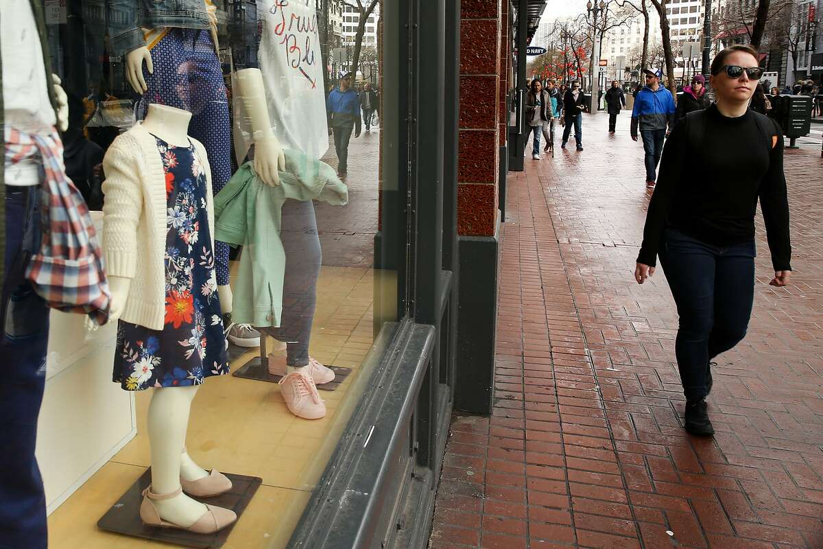 A woman walks past the Old Navy on Market Street on Friday, Jan. 20, 2017 in San Francisco, Calif. Congress is considering changes to the tax system that will make companies that import goods pay more taxes. Consumers might then face higher prices. Gap, which owns Old Navy, makes a lot of its clothing overseas.
