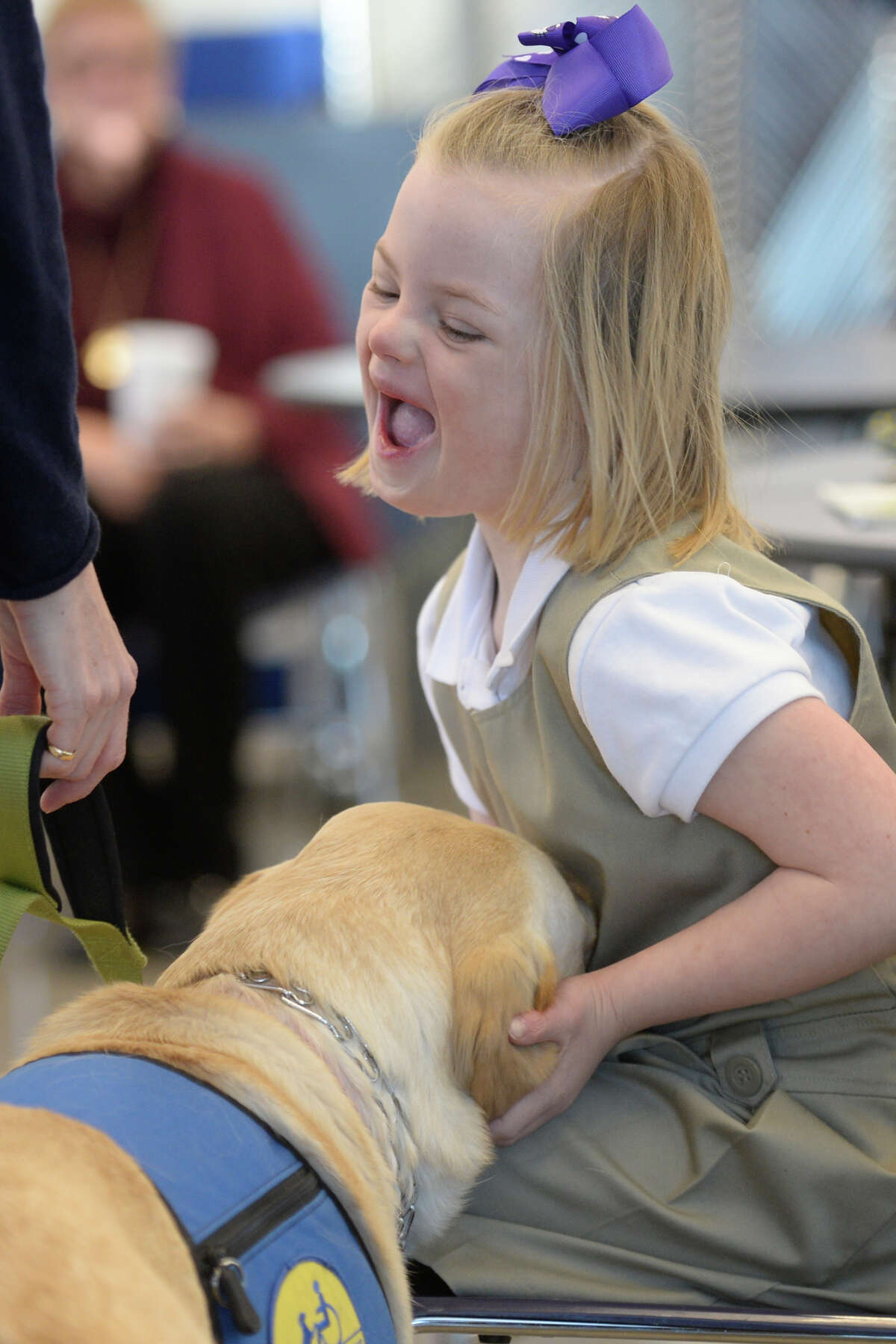 Piper, a service dog with the Ham family and representing Canine Companions for Independence, performs a demonstration with Emery Ham for Trinity School kindergartners on Friday, Jan. 20, 2017, at Trinity School. James Durbin/Reporter-Telegram