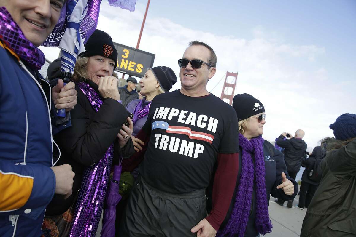 Pat Waters of San Francisco wears an Impeach Trump shirt during Bridge Together on Friday, January 20, 2017 in San Francisco Calif.