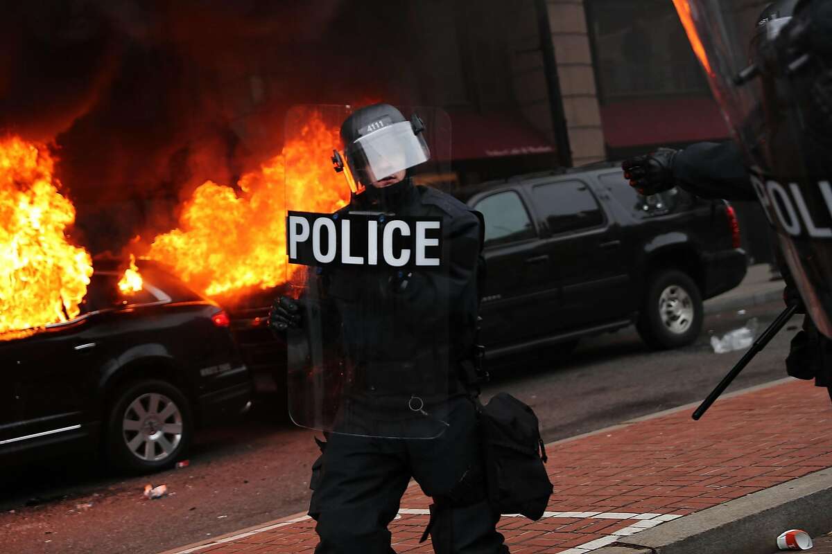 Police and demonstrators clash in downtown Washington after a limo was set on fire following the inauguration of President Donald Trump on January 20, 2017 in Washington, DC. Washington and the entire world have watched the transfer of the United States presidency from Barack Obama to Donald Trump, the 45th president.