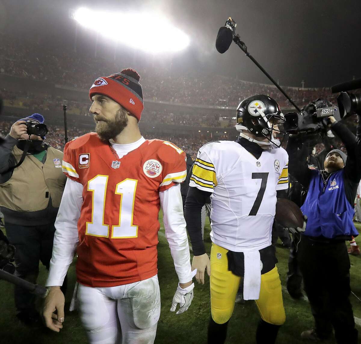 Kansas City Chiefs quarterback Alex Smith (11) walks off the field after talking with Pittsburgh Steelers quarterback Ben Roethlisberger (7) at the end of an NFL divisional playoff football game Sunday, Jan. 15, 2017, in Kansas City, Mo. The Steelers won 18-16. (AP Photo/Charlie Riedel)