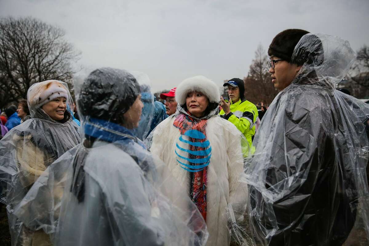 (l-r) Trump supporters Mary Hongdong, Yiying Wang, Lisa Liu and Steven Lu chat as they decide where to stand at Donald Trump's Presidential inauguration in Washington, D.C., on Friday, Jan. 20, 2017.