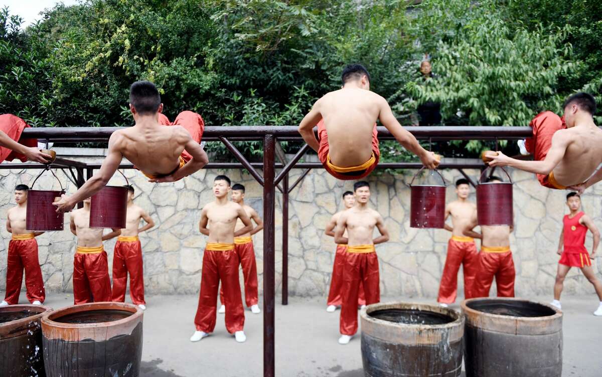 ZHENGZHOU, CHINA - OCTOBER 14: Students of martial art schools do rehearsal for the upcoming 11th International Shaolin Wushu Festival on October 14, 2016 in Zhengzhou, Henan Province of China. The 11th International Shaolin Wushu Festival will be held from October 16 to October 20 in Henan Province, the birthplace of Shaolin Wushu in China. The festival will include group calisthenics, martial arts sitcom to promote cultural communication of martial arts. (Photo by VCG/VCG via Getty Images)