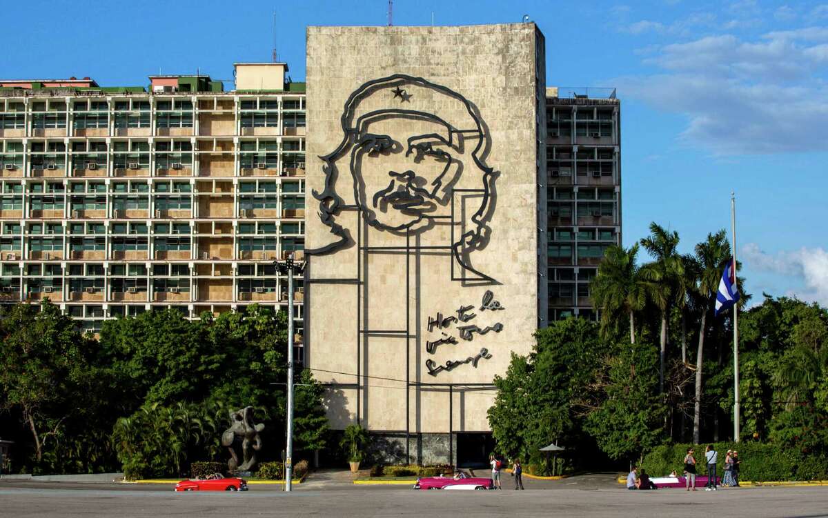 FILE - This Nov. 27, 2016 file photo shows the iconic image of Cuba's revolutionary hero Ernesto "Che" Guevara, at Revolution Square near the Ministry of Interior in Havana, Cuba. Some Americans may rush to see Cuba in 2017, worried that the Trump administration will tighten travel rules. Others may postpone plans until they see what the new administration does. (AP Photo/Desmond Boylan, File)
