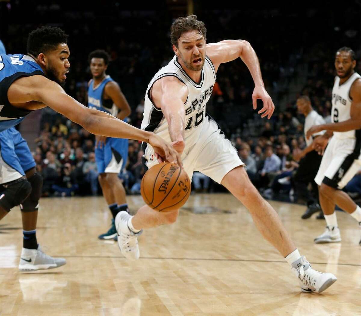 Spurs' Pau Gasol (16) fights for a loose ball against Minnesota Timberwolves' Karl-Anthony Towns (32) during their game at the AT&T Center on Tuesday, Jan. 17, 2017.