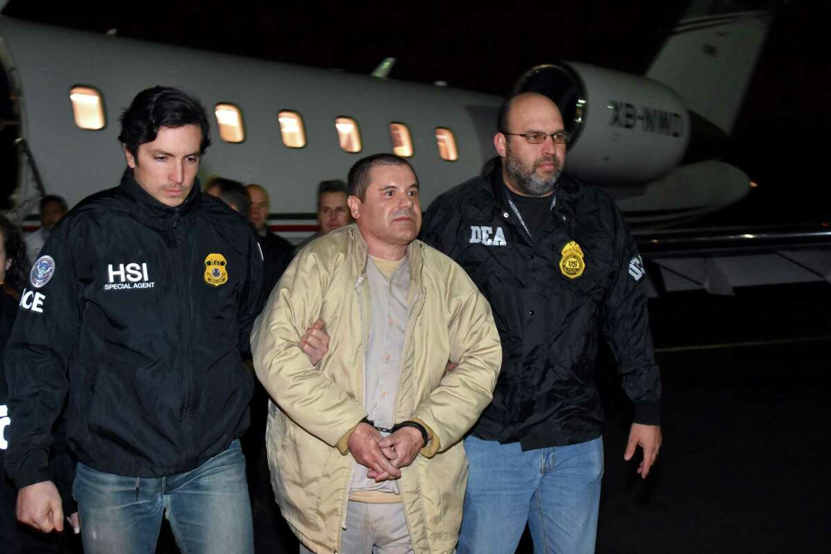 U.S. authorities escort Joaquin "El Chapo" Guzman from a plane at Long Island MacArthur Airport on Jan. 19 in Ronkonkoma, N.Y. The infamous drug kingpin who twice escaped from prisons in Mexico was extradited of the U.S. to face drug trafficking and other charges.