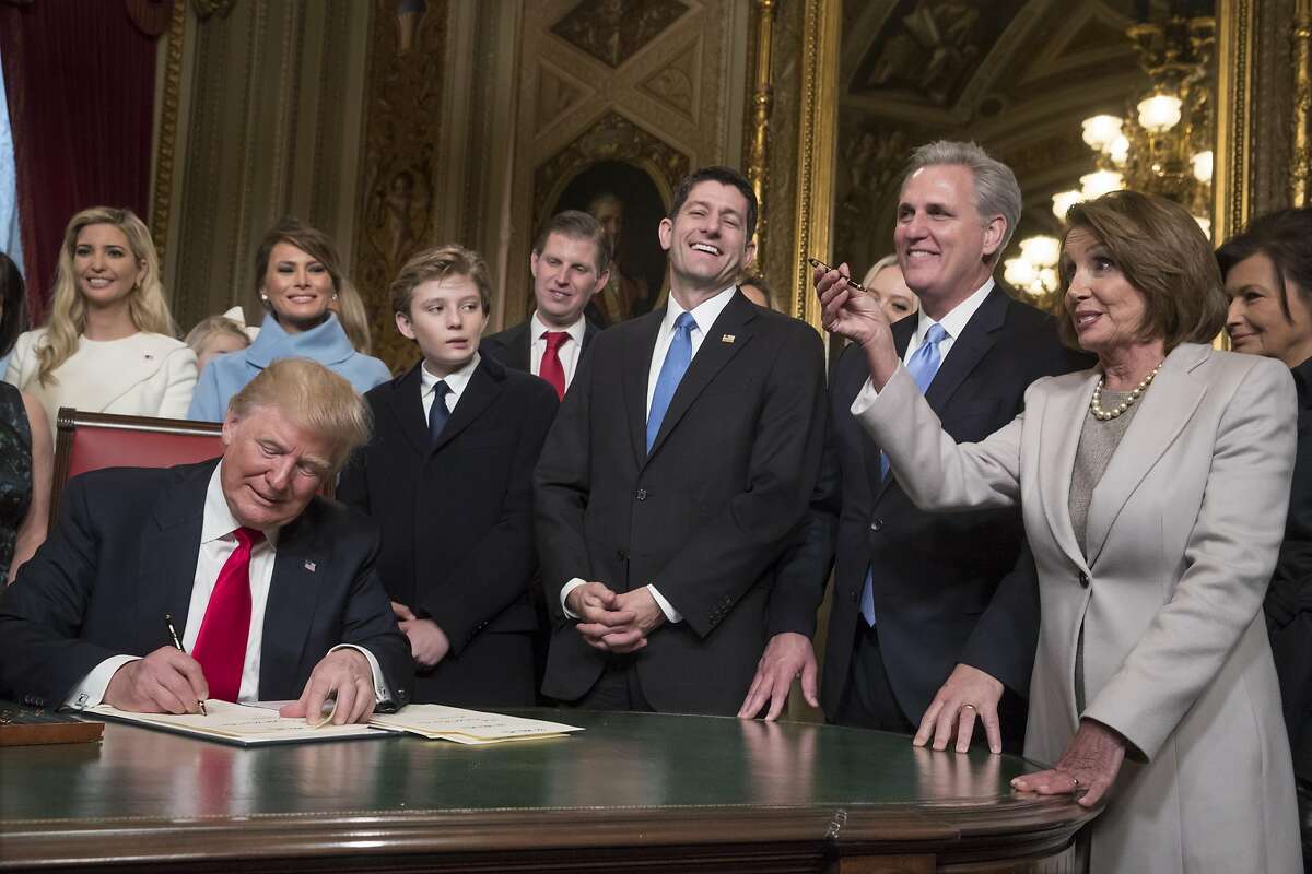WASHINGTON, DC - JANUARY 20: President Donald Trump is joined by the Congressional leadership and his family as he formally signs his cabinet nominations into law, in the President's Room of the Senate, at the Capitol in Washington, Friday, Jan. 20, 2017. From left behind Trump are, Ivanka Trump, Melania Trump, their son Barron Trump, Eric Trump, Speaker of the House Paul Ryan, (R-WI), Majority Leader Kevin McCarthy, (D-CA), and House Minority Leader Nancy Pelosi,(D-CA). (Photo by J. Scott Applewhite - Pool/Getty Images)