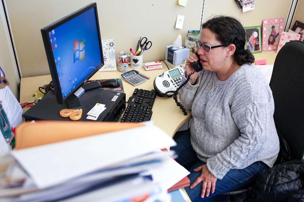 Resource navigation manager, Ellen Novogrodsky, makes a phone call to California Department of Public Health at SF AIDS Foundation on Thursday, January 19, 2017 in San Francisco, Calif.