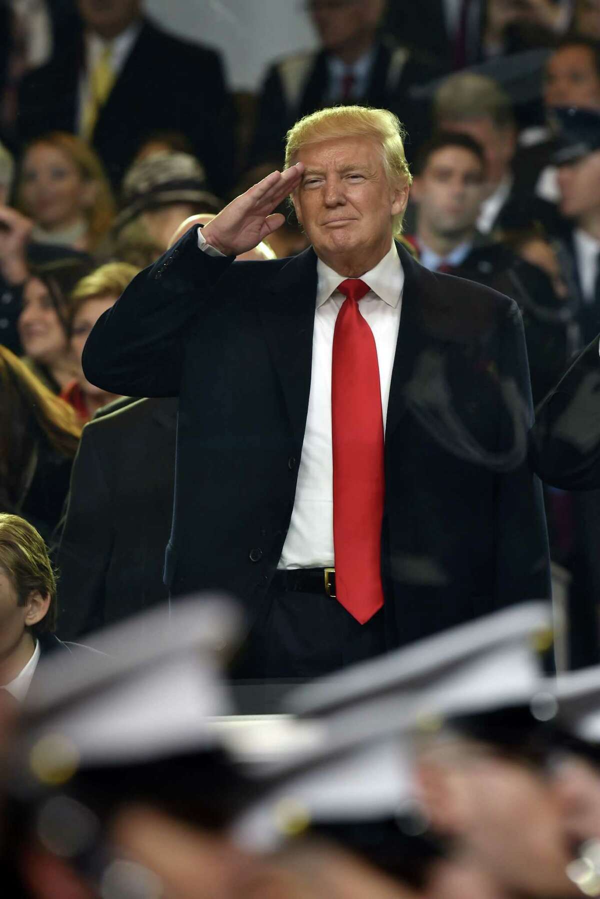 President Donald Trump salutes during the presidential inaugural parade on Jan. 20, 2017 in Washington, D.C. (Nicholas Kamm/ AFP/Getty Images