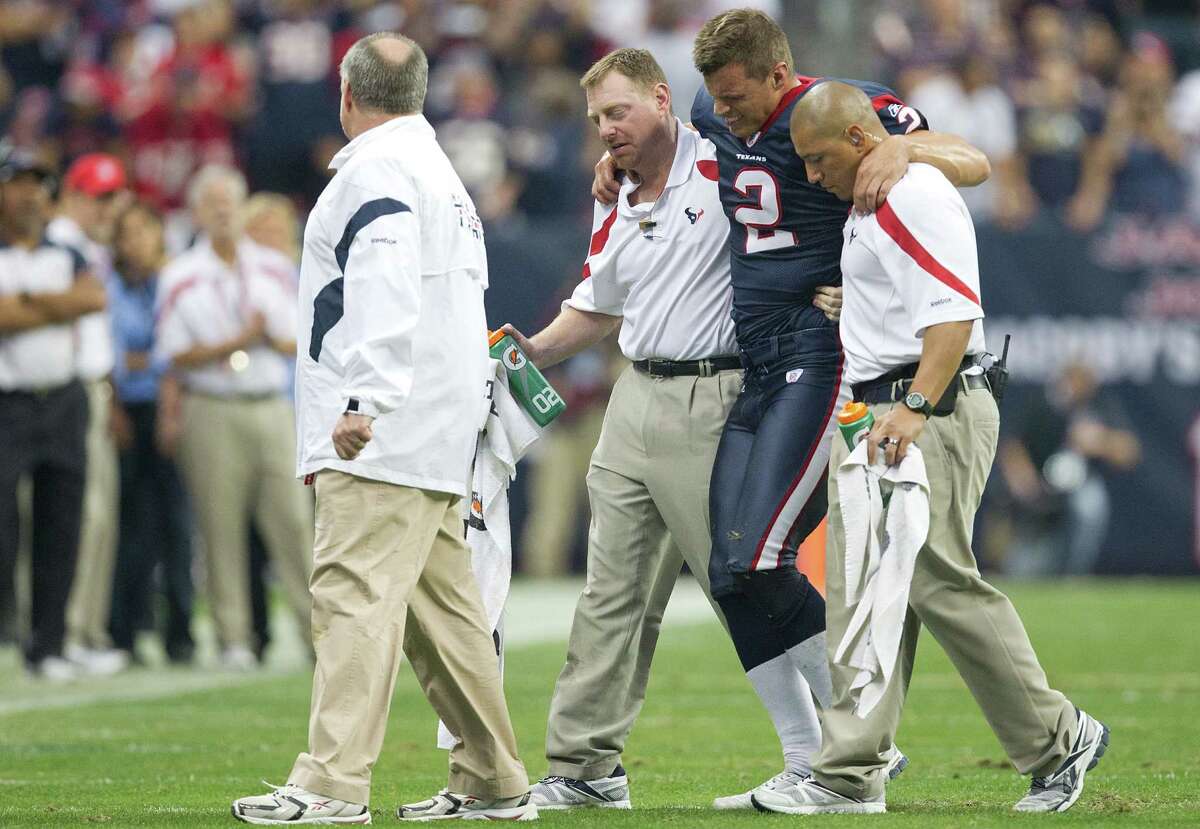 Houston Texans punter Brett Hartmann (2) is helped off the field after being injured during the fourth quarter of an NFL football game against the Atlanta Falcons at Reliant Stadium on Sunday, Dec. 4, 2011, in Houston. The Texans won the game 17-10. ( Smiley N. Pool / Houston Chronicle )