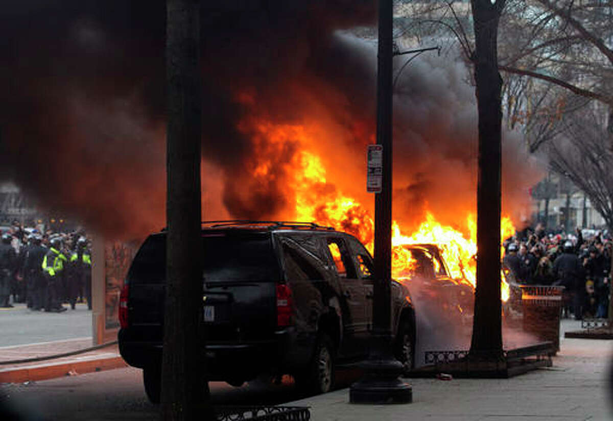 Demonstrators torch a car during the demonstration in downtown Washington Friday, Jan. 20, 2017, during the inauguration of President Donald Trump. ( AP Photo/Jose Luis Magana)