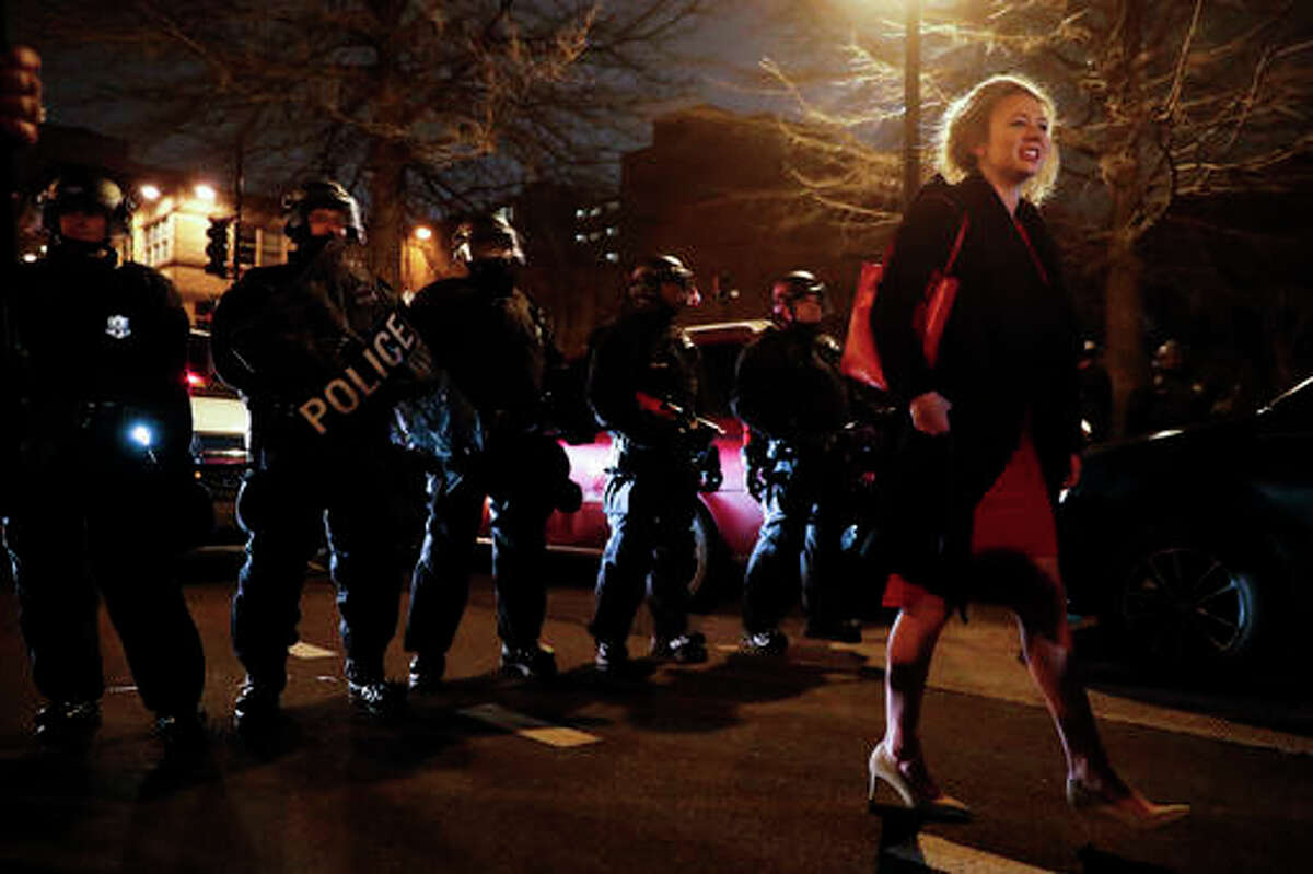 A party-goer is turned away from walking down the street by a line of riot police during a demonstration after the inauguration of President Donald Trump, Friday, Jan. 20, 2017, in Washington. (AP Photo/John Minchillo)
