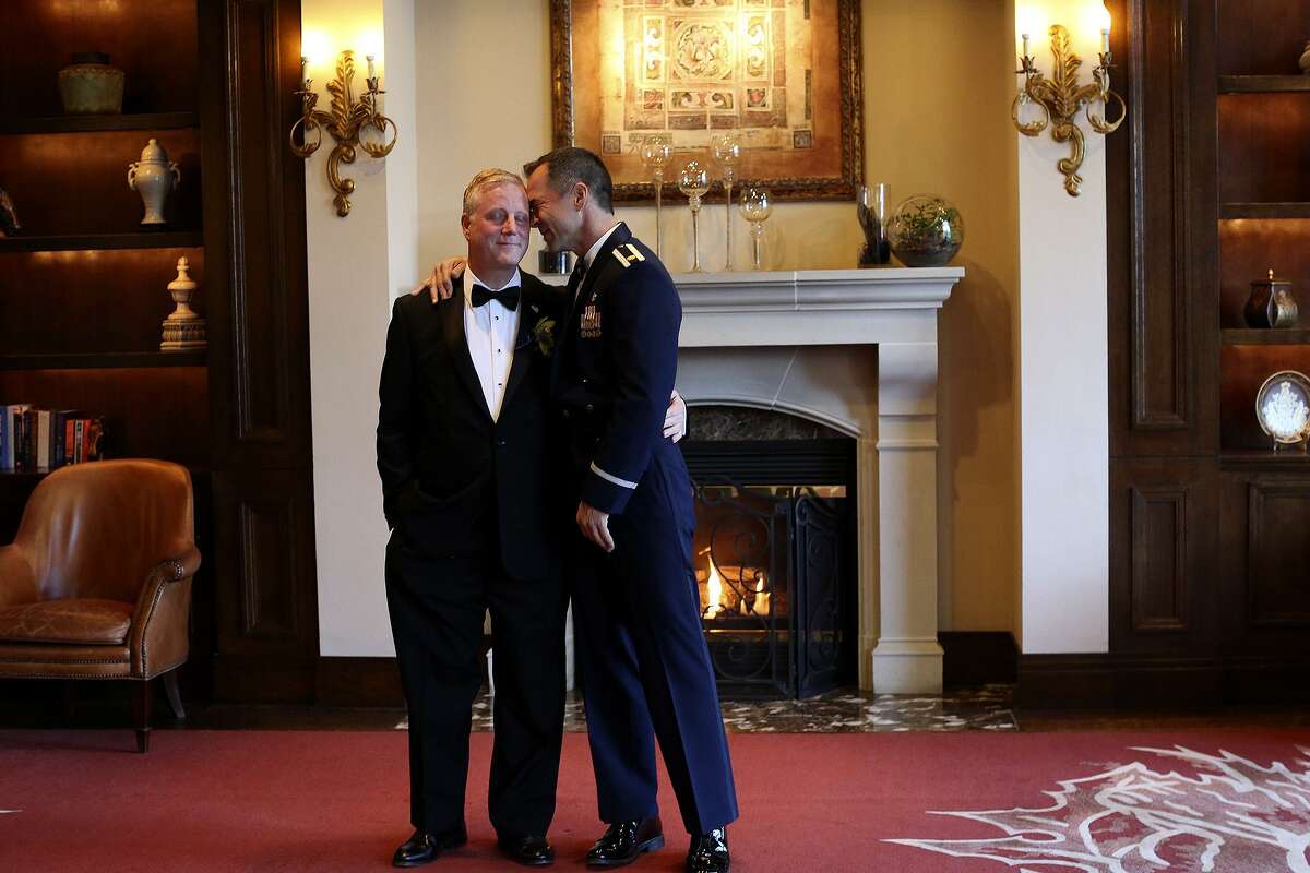 Mark Phariss, left, and Vic Holmes share a moment before they begin group photos with family and friends before their wedding in Frisco on Saturday, Nov. 21, 2015.