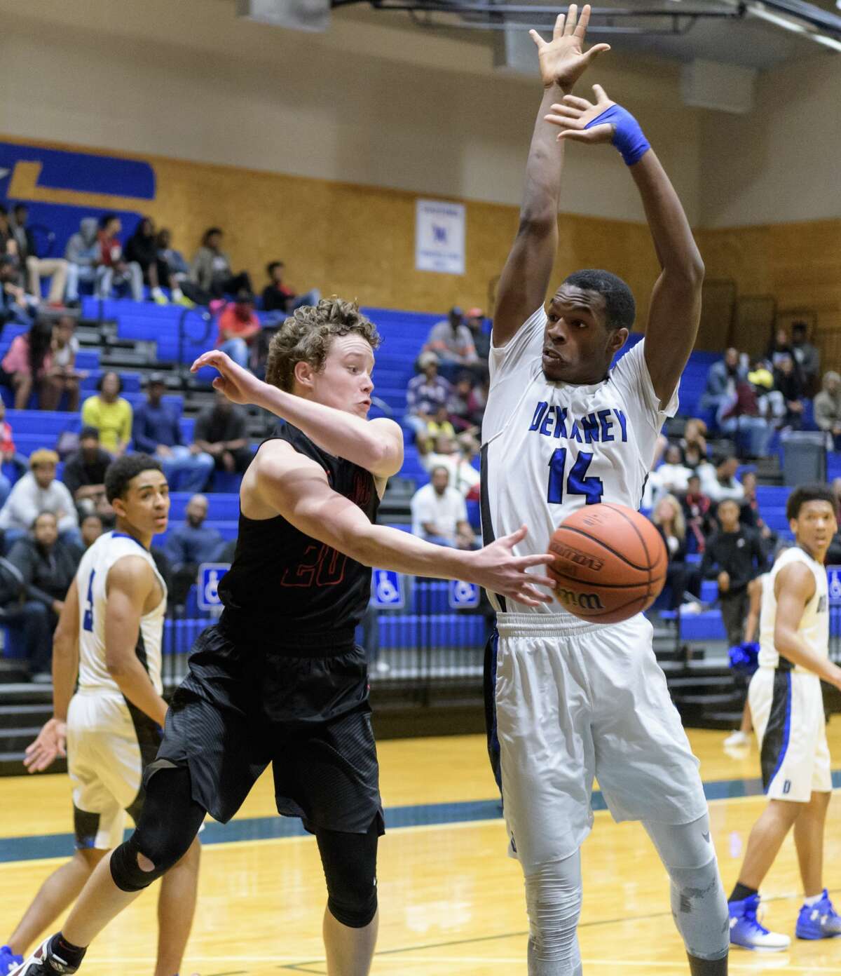 Sam Martin (20) of the Westfield Mustangs passes the ball around Anthony Nash (14) of the Dekaney Wildcats in a high school basketball game on Friday, January 20, 2017 at the Dekaney High School Gym in Houston Texas.